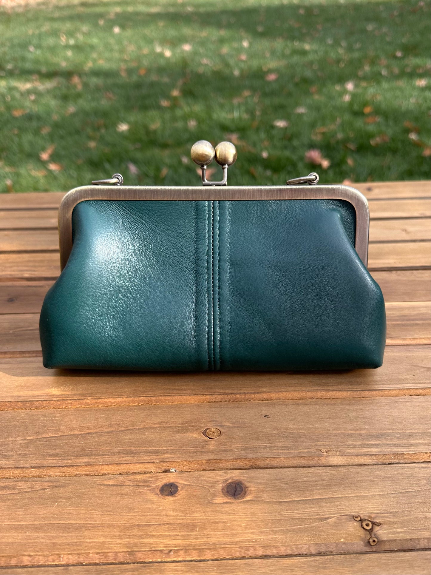 Nappa Forest Green Leather kiss lock purse with bronze hardware. Wear as a clutch, crossbody, or shoulder bag. Holds phone, cards, and essentials. Made in Maryland.
