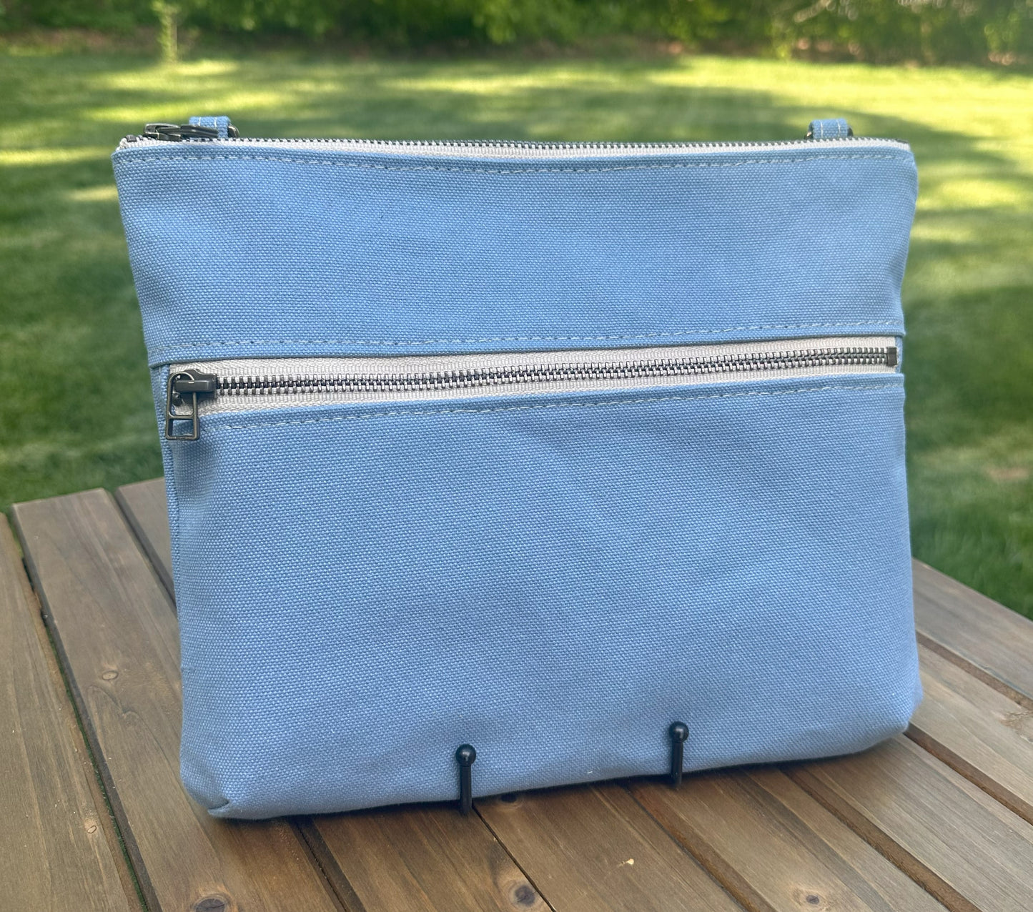 Front View Handcrafted Canvas Bayside Slim Crossbody Bag in Light Blue canvas with cotton canvas lining and adjustable Splenda vegetable-tanned leather strap. Lightweight and perfect for everyday wear.