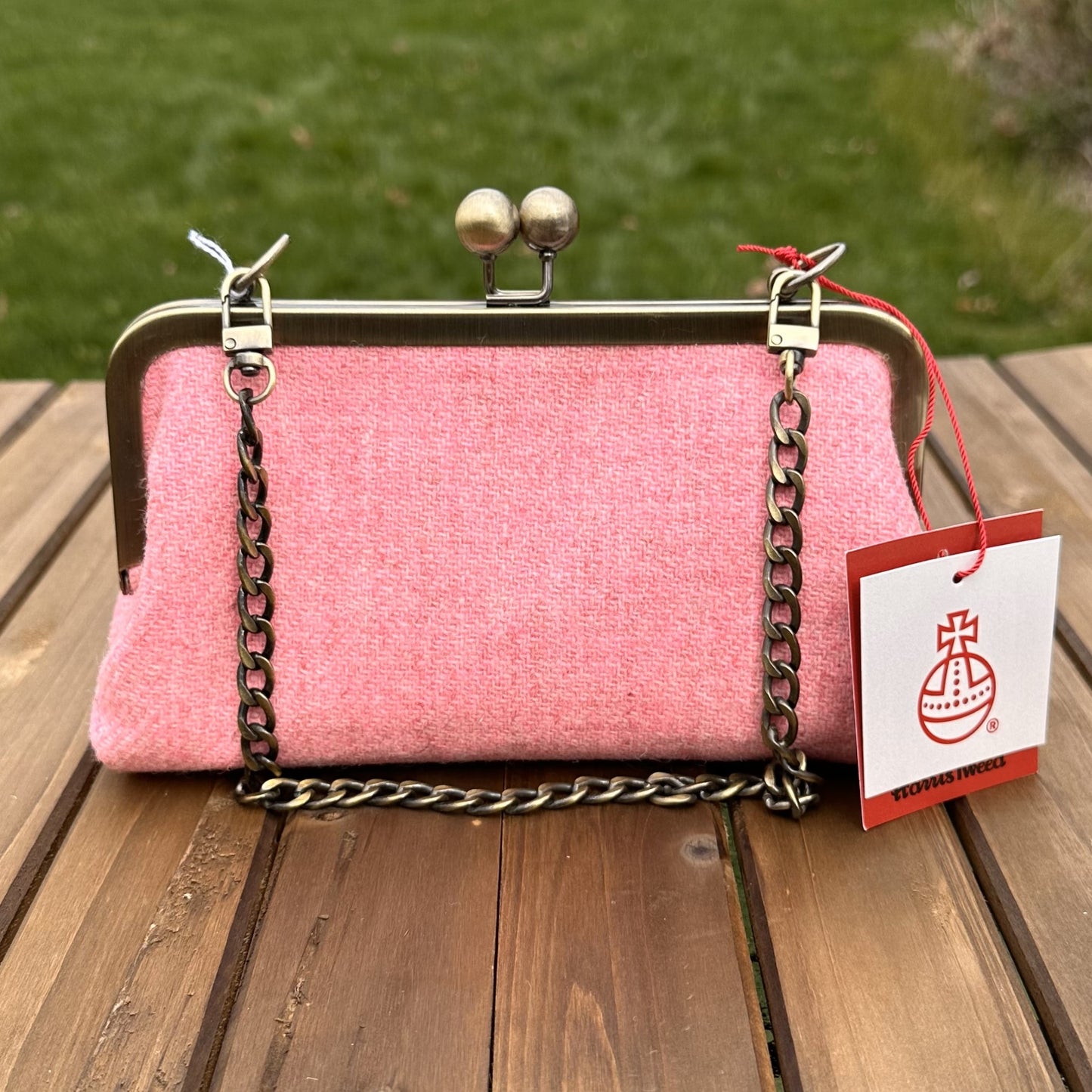 Harris Tweed® kiss lock purse in Pink Twill with bronze hardware. Wear as a clutch, attach chain for shoulder or crossbody wear. Holds phone, cards, and small items. Timeless design handcrafted in Maryland.