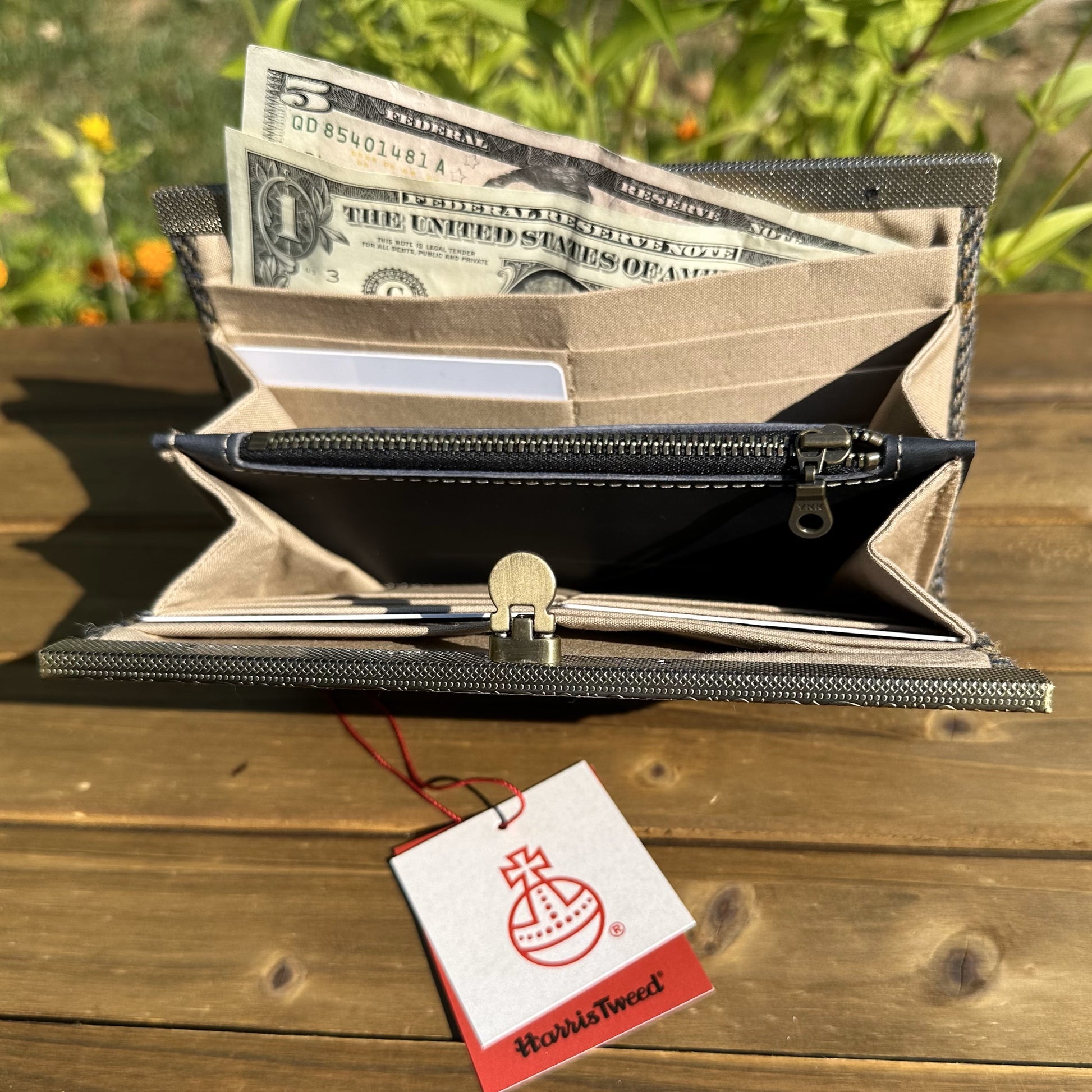 Interior view of the open Harris Tweed® Large Rock Hall Wallet, highlighting the organization features: card slots, cash slip pocket, and leather zipper coin pouch.