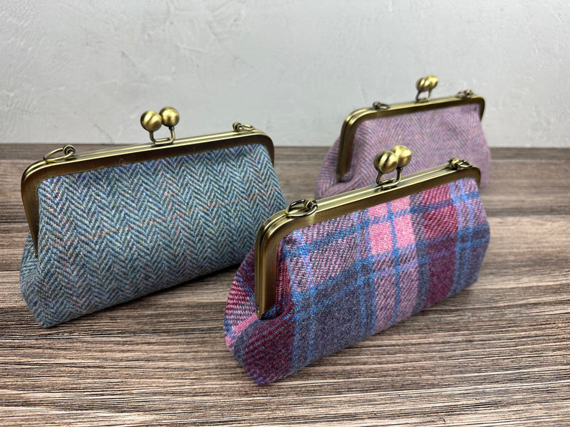 Collection of handcrafted Harris Tweed® kiss lock purses with bronze hardware. Classic clutch style with 2 card slots, fits a phone and small essentials. Wear as a clutch, shoulder bag, or crossbody. Made in Maryland, perfect for special occasions.