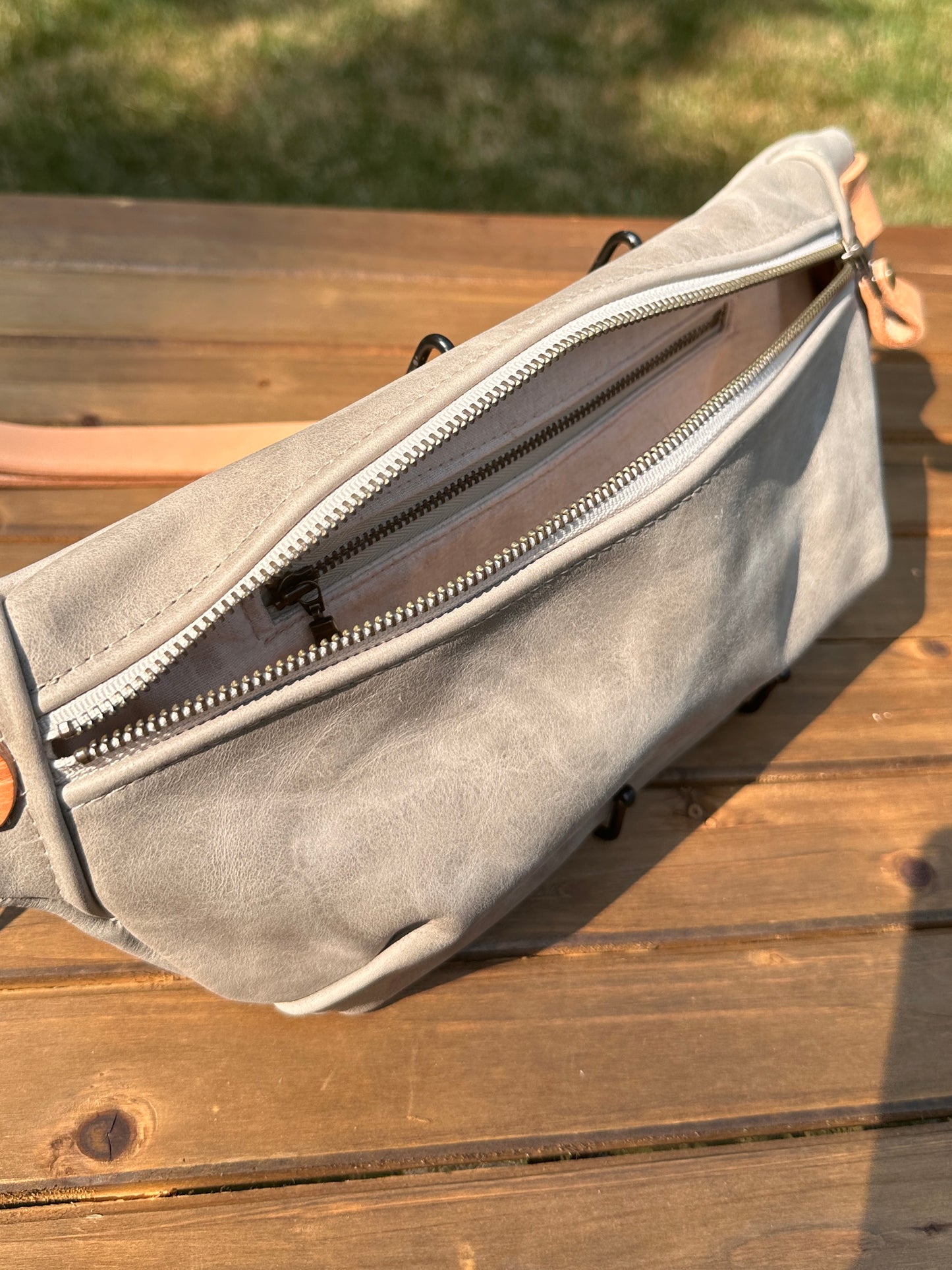 Interior view of Leather Spinnaker Sling bag in Distressed Gray Leather with linen lining and interior zipper pocket. Slim and practical leather sling bag handcrafted in Maryland.
