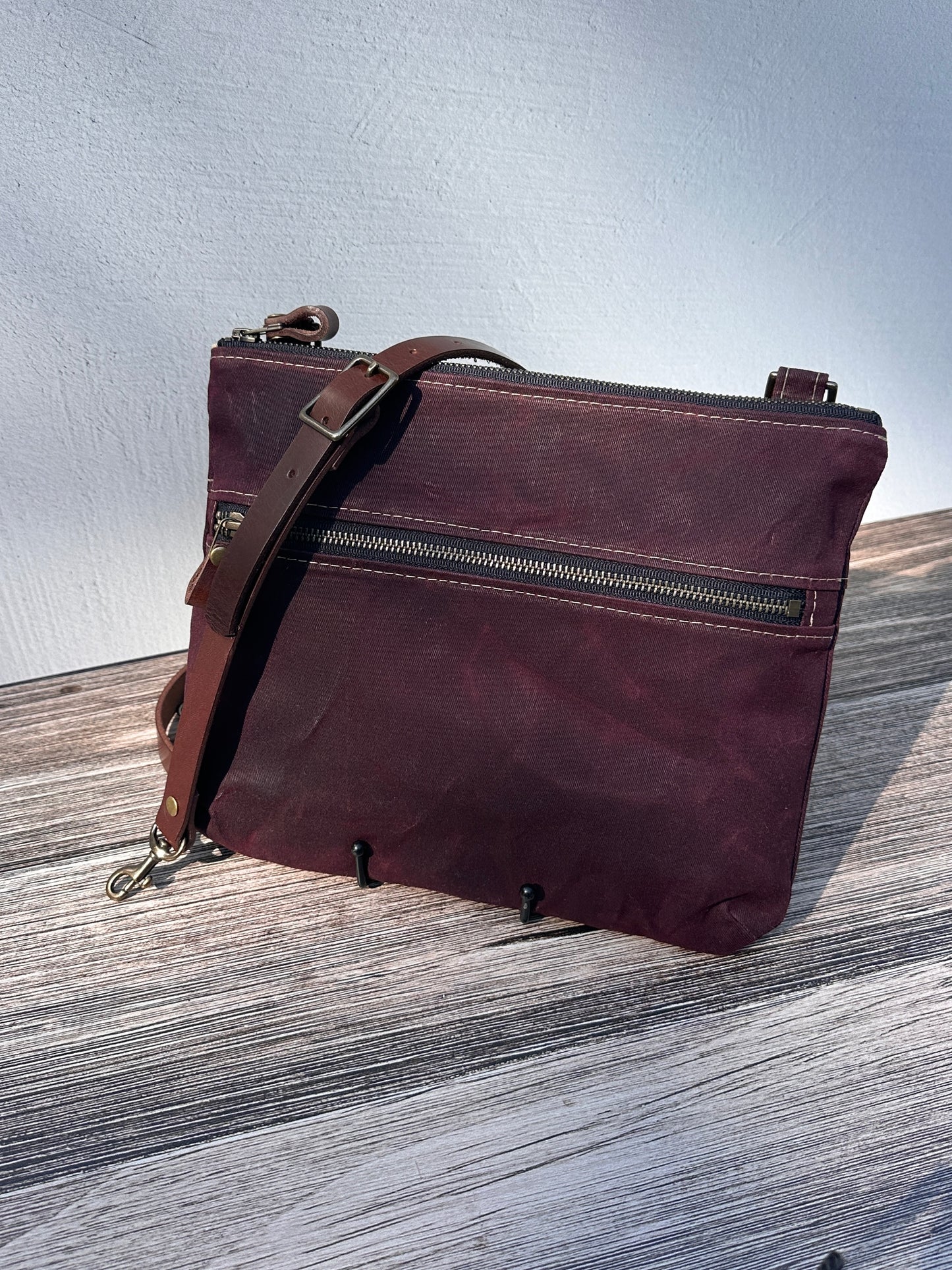Front View Handcrafted Canvas Bayside Slim Crossbody Bag in Burgundy Waxed Twill with cotton canvas lining and adjustable Splenda vegetable-tanned leather strap. Lightweight and perfect for everyday wear.