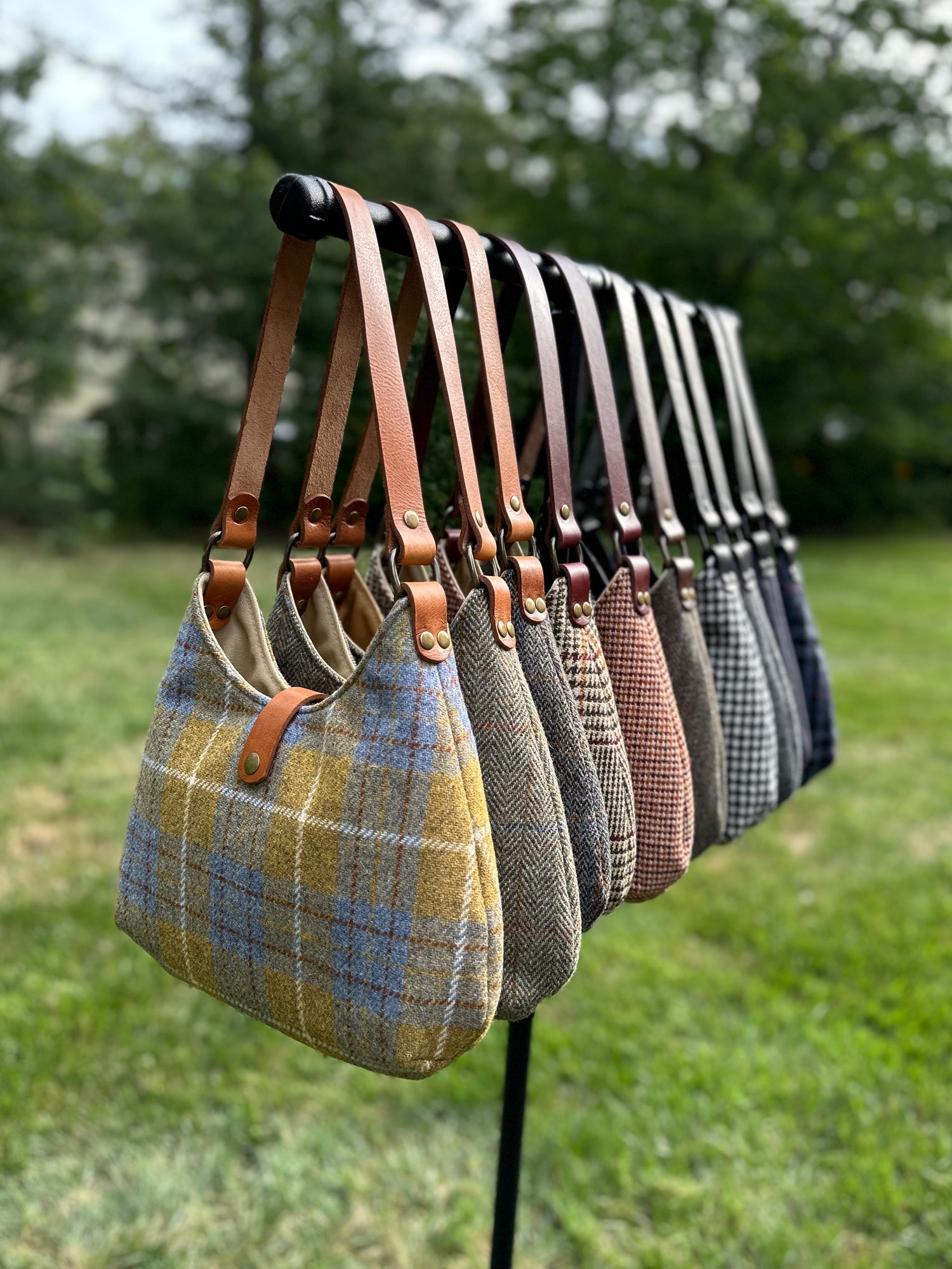 Harris Tweed® Rhode River Shoulder Bags group shot, 10 fabric-and-leather combos. Handcrafted in Maryland