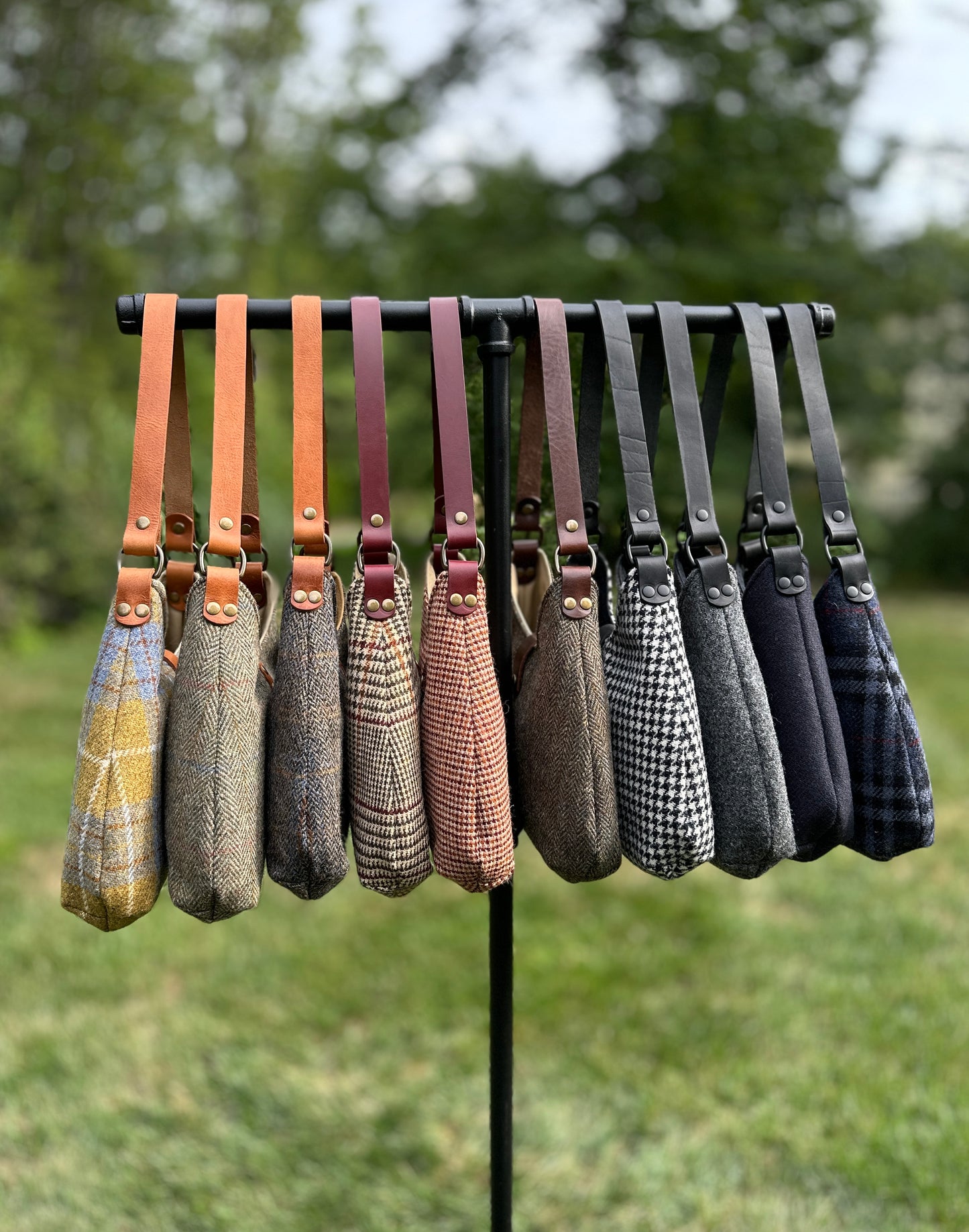 Harris Tweed® Rhode River Shoulder Bags group shot, 10 fabric-and-leather combos. Handcrafted in Maryland