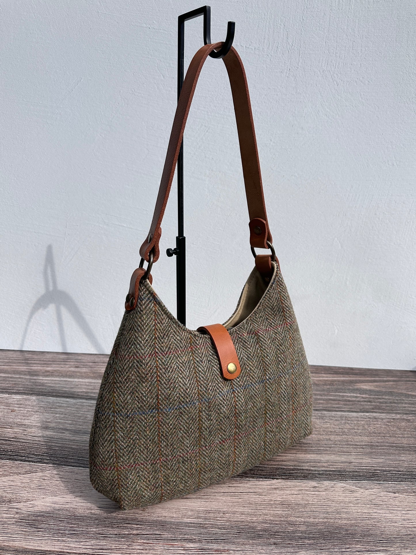 Front view Green Mix Herringbone Harris Tweed® Rhode River Shoulder Bags, Cognac Leather with Antique Brass Hardware. Handcrafted in Maryland