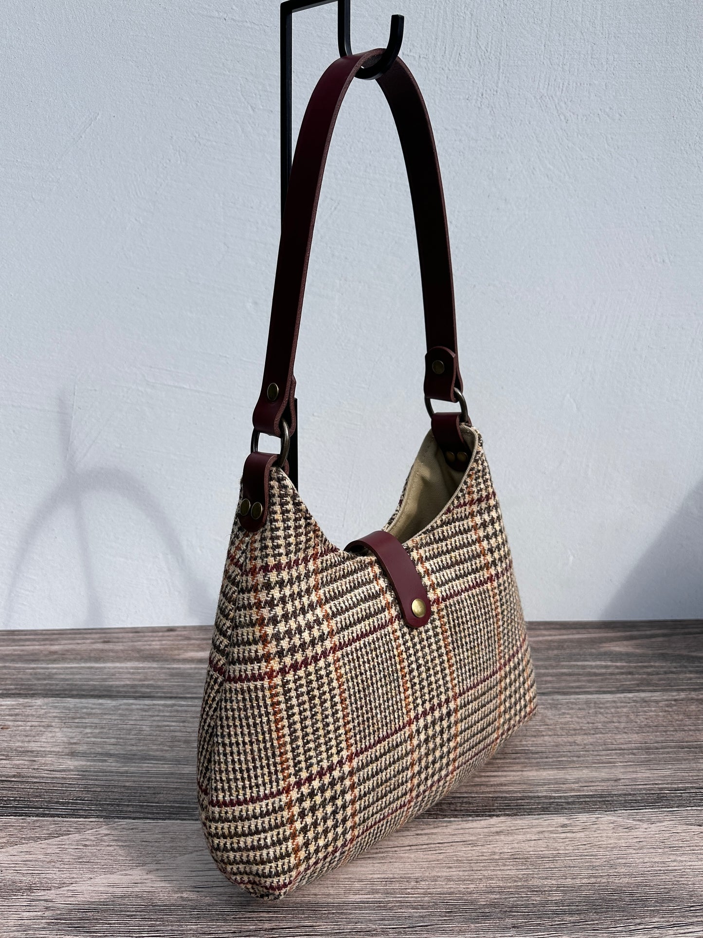 Front view Glen Plaid Harris Tweed® Rhode River Shoulder Bags, Bordeaux Leather with Antique Brass Hardware. Handcrafted in Maryland