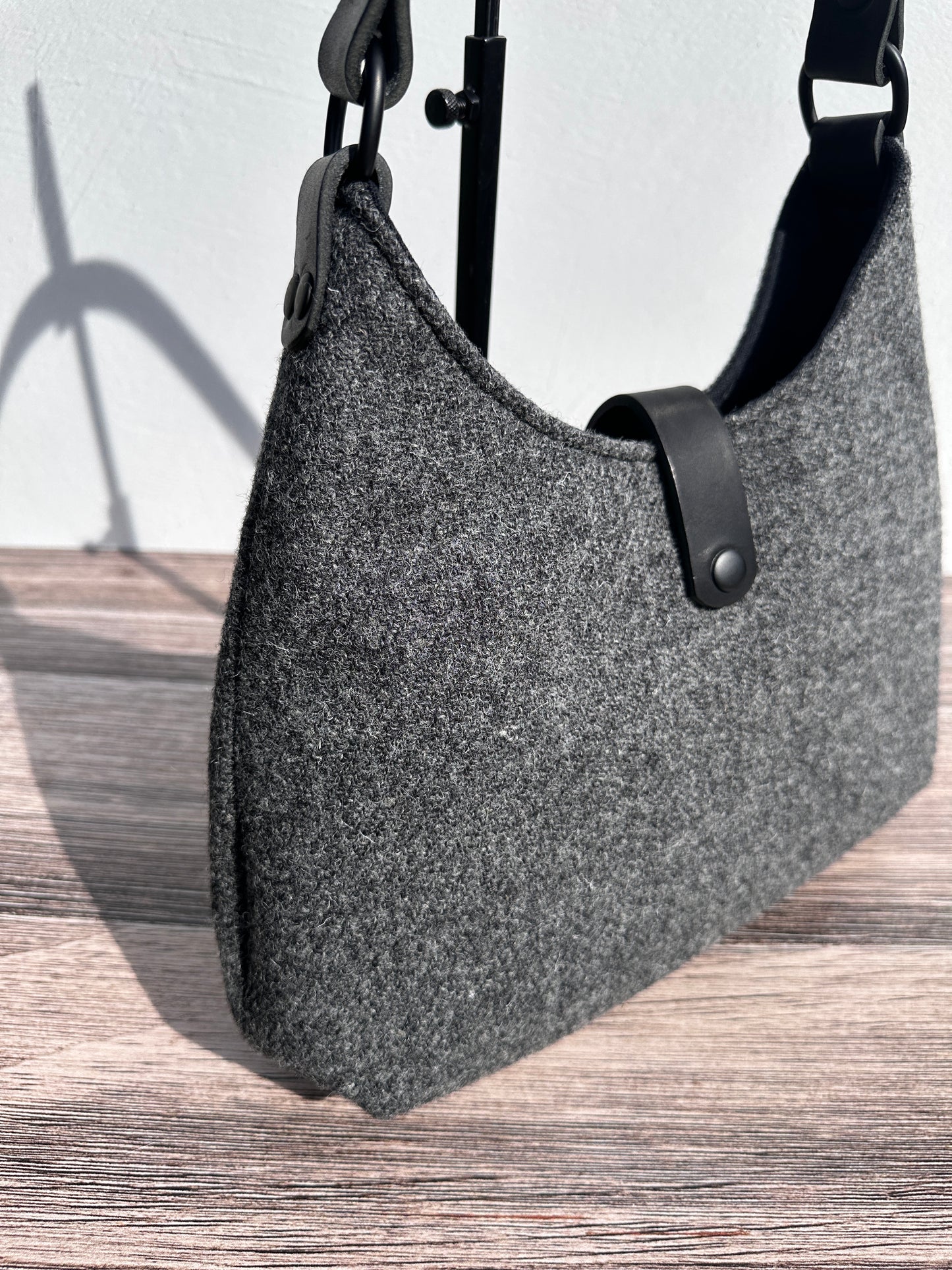 Close up view Mid Grey Twill Harris Tweed® Rhode River Shoulder Bags, Black Leather with Black Matte Hardware. Handcrafted in Maryland