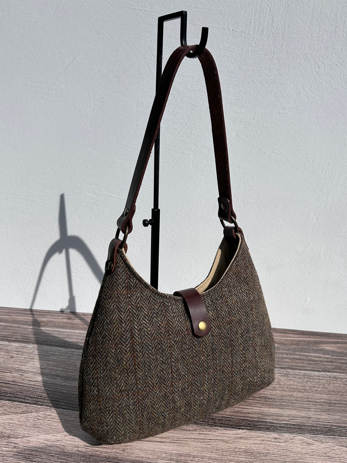 Front view Green and Brown Herringbone Harris Tweed® Rhode River Shoulder Bags, Dark Brown Leather with Antique Brass Hardware. Handcrafted in Maryland