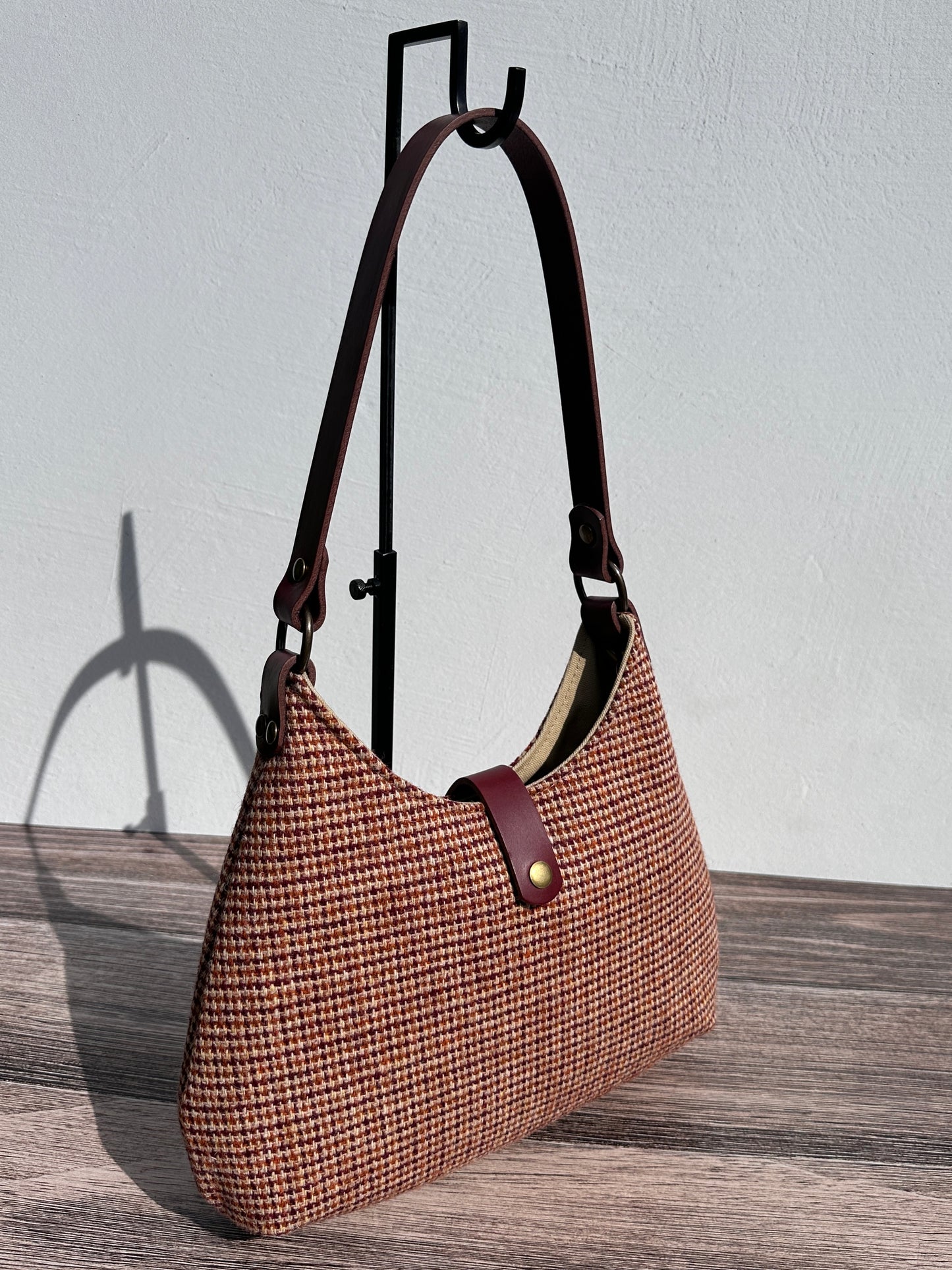 Front view Fawn & Amber Harris Tweed® Rhode River Shoulder Bags, Bordeaux Leather with Antique Brass Hardware. Handcrafted in Maryland