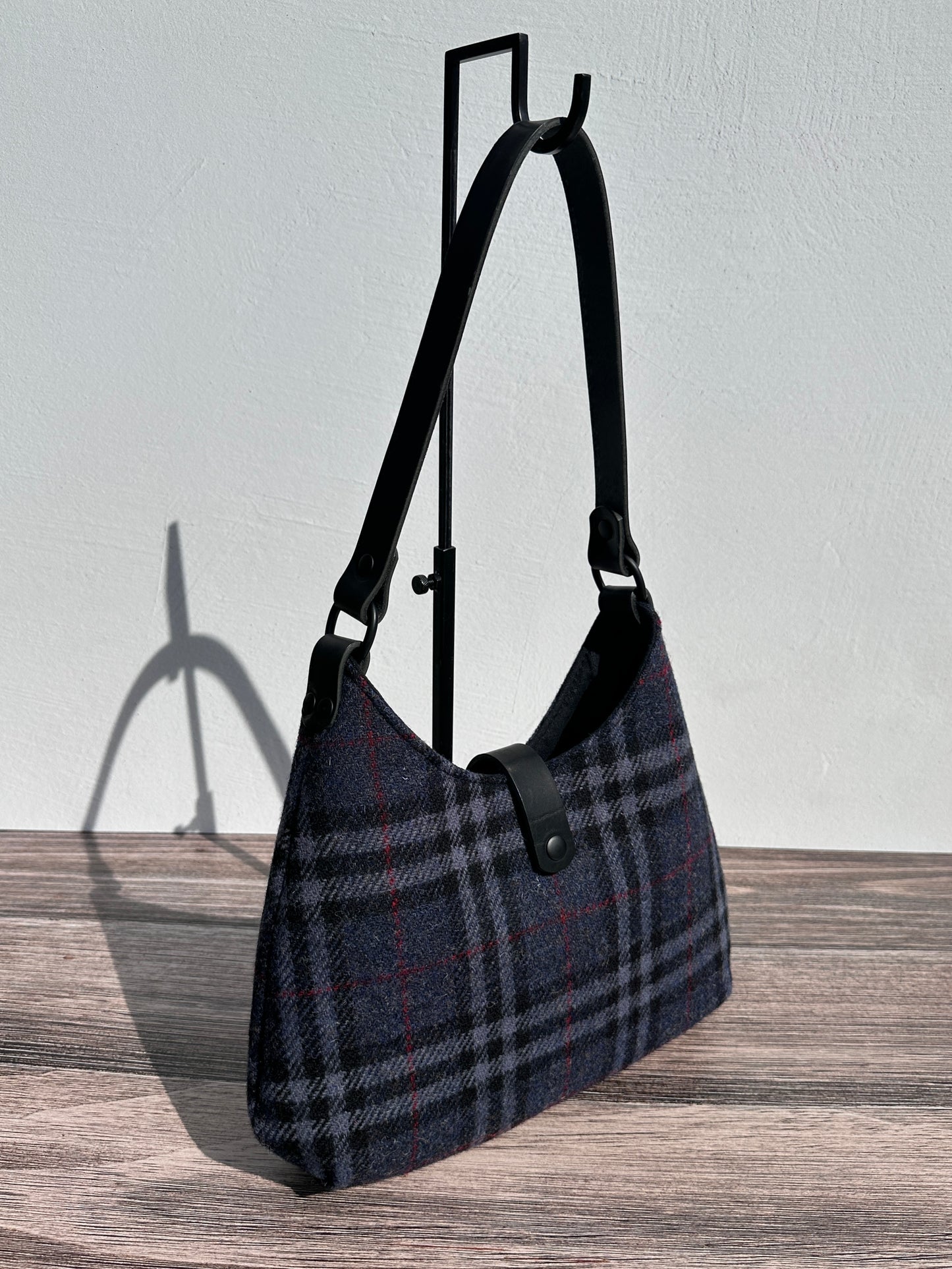 Front view Navy Black & Grey Tartan Harris Tweed® Rhode River Shoulder Bags, Black Leather with Black Matte Hardware. Handcrafted in Maryland