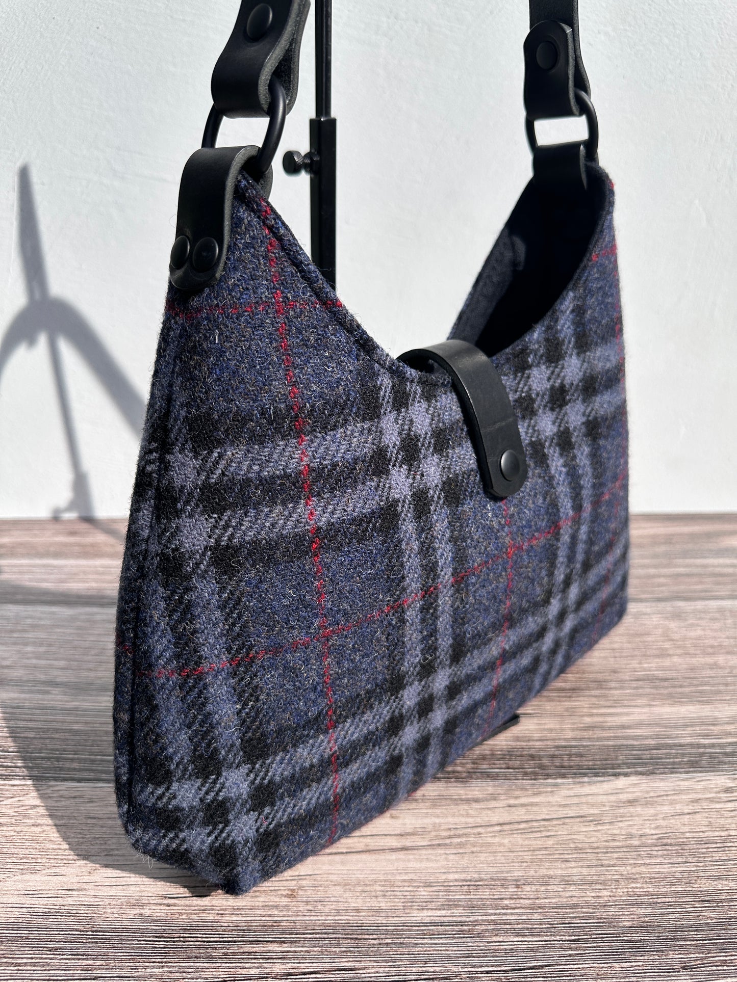 Close up view Navy Black & Grey Tartan Harris Tweed® Rhode River Shoulder Bags, Black Leather with Black Matte Hardware. Handcrafted in Maryland