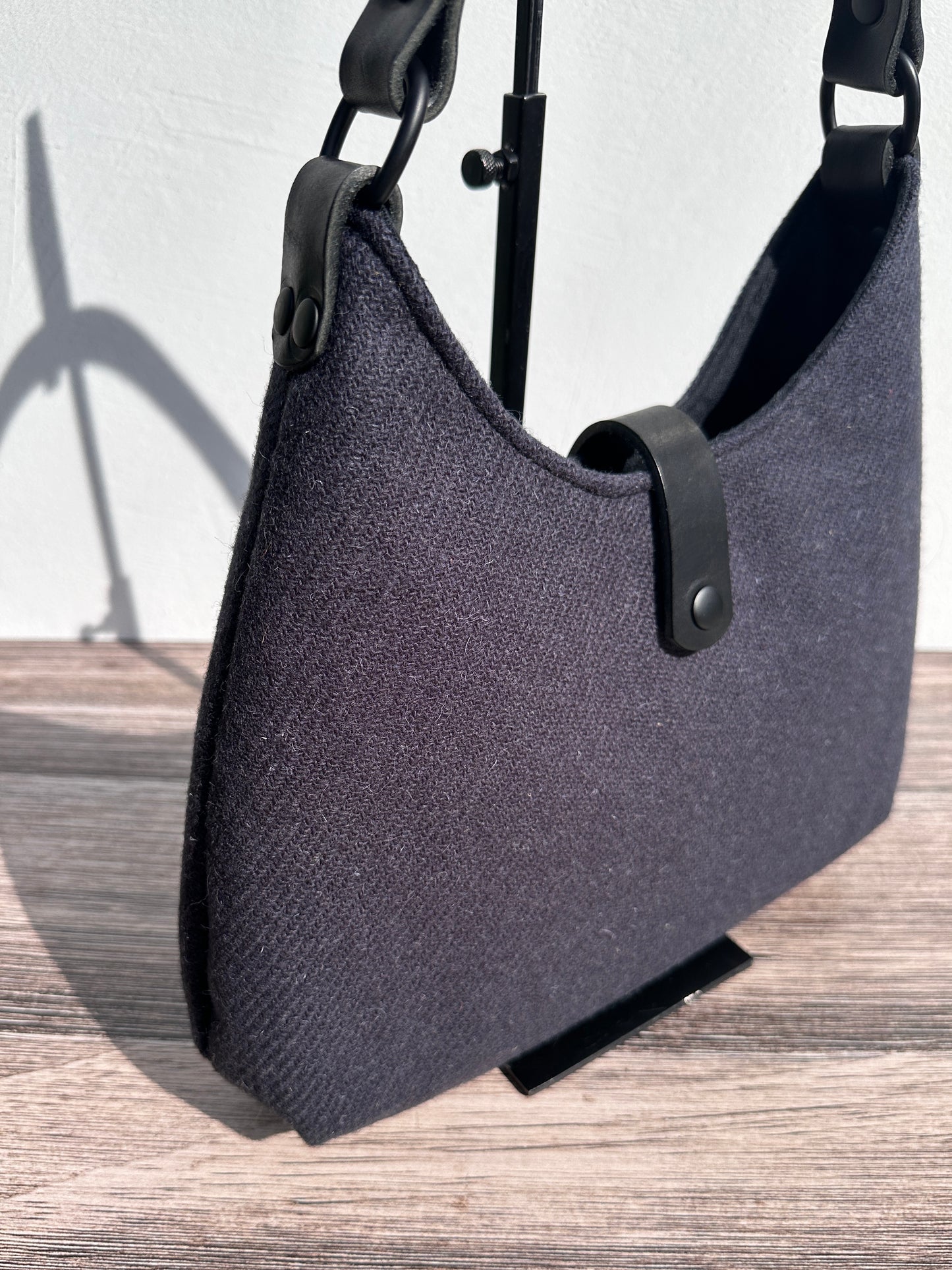Close Up view Smoky Grey Harris Tweed® Rhode River Shoulder Bags, Black Leather with Black Matte Hardware. Handcrafted in Maryland