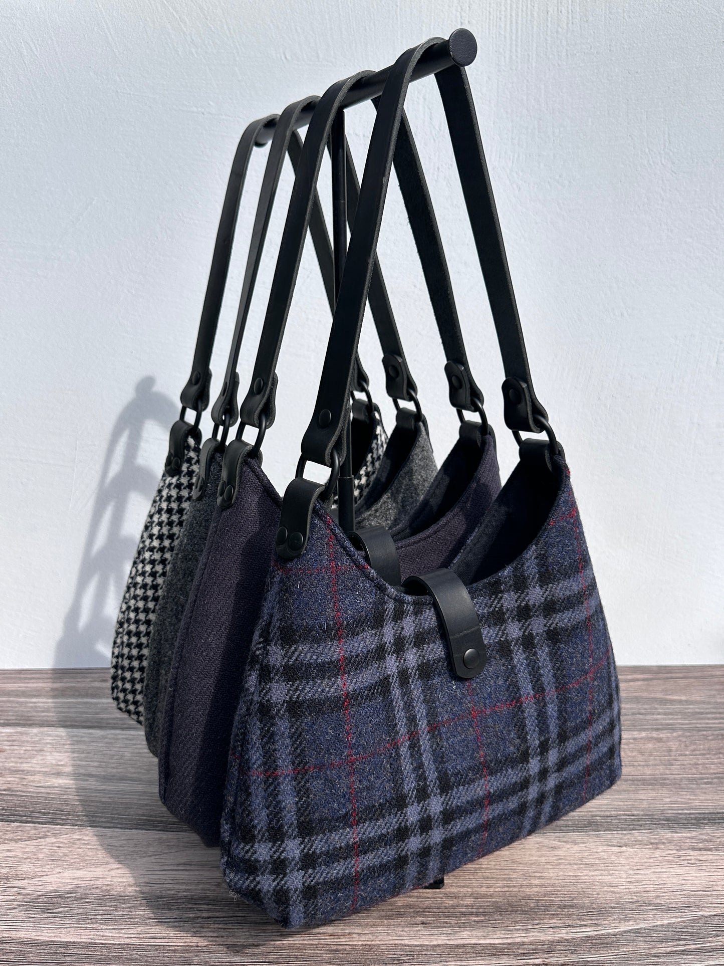 Harris Tweed® Rhode River Shoulder Bags four bags, with different prints and Black Leather and Black Matte Hardware. Handcrafted in Maryland