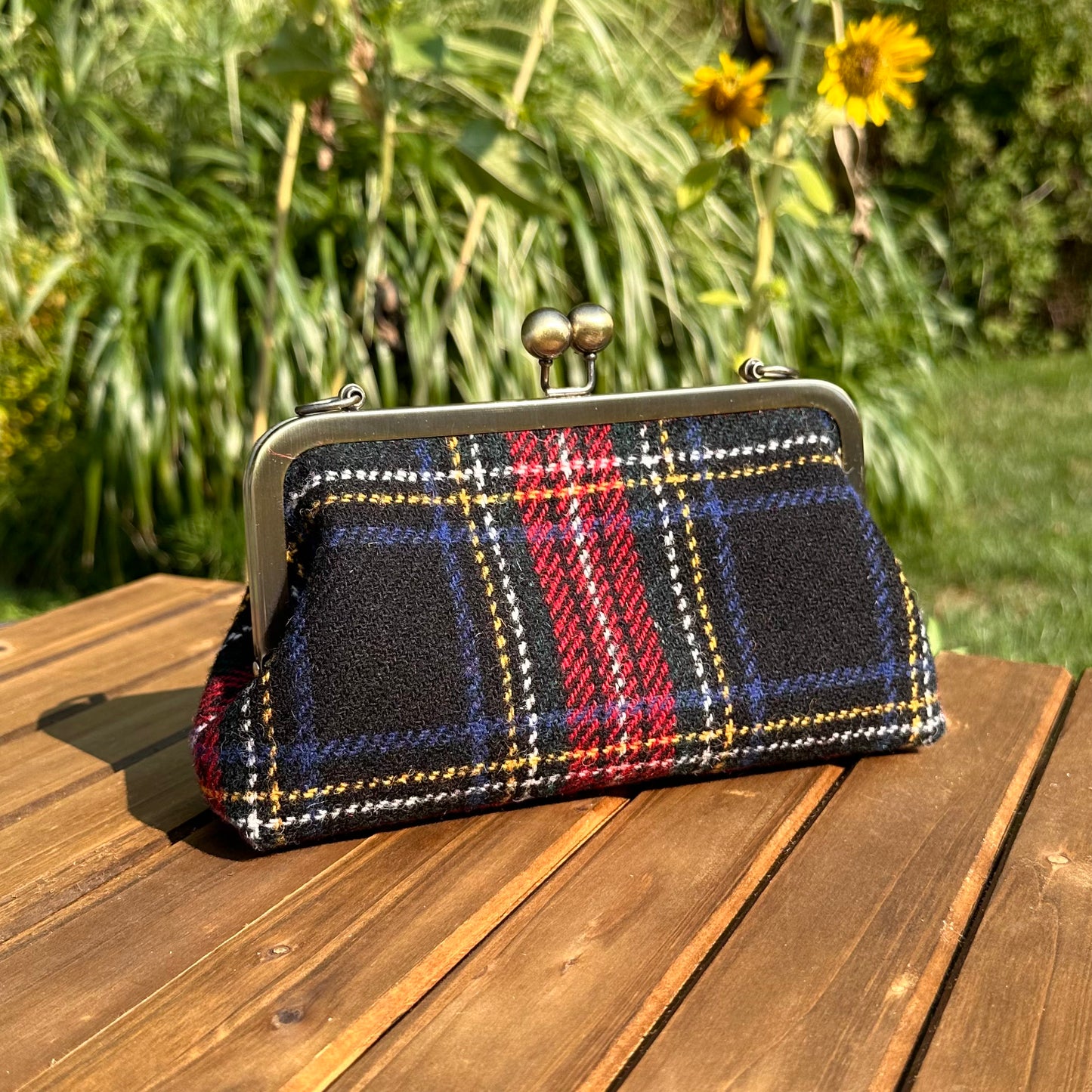 Harris Tweed® kiss lock purse in Stewart Plaid with bronze hardware. Wear as a clutch, attach chain for shoulder or crossbody wear. Holds phone, cards, and small items. Timeless design handcrafted in Maryland.