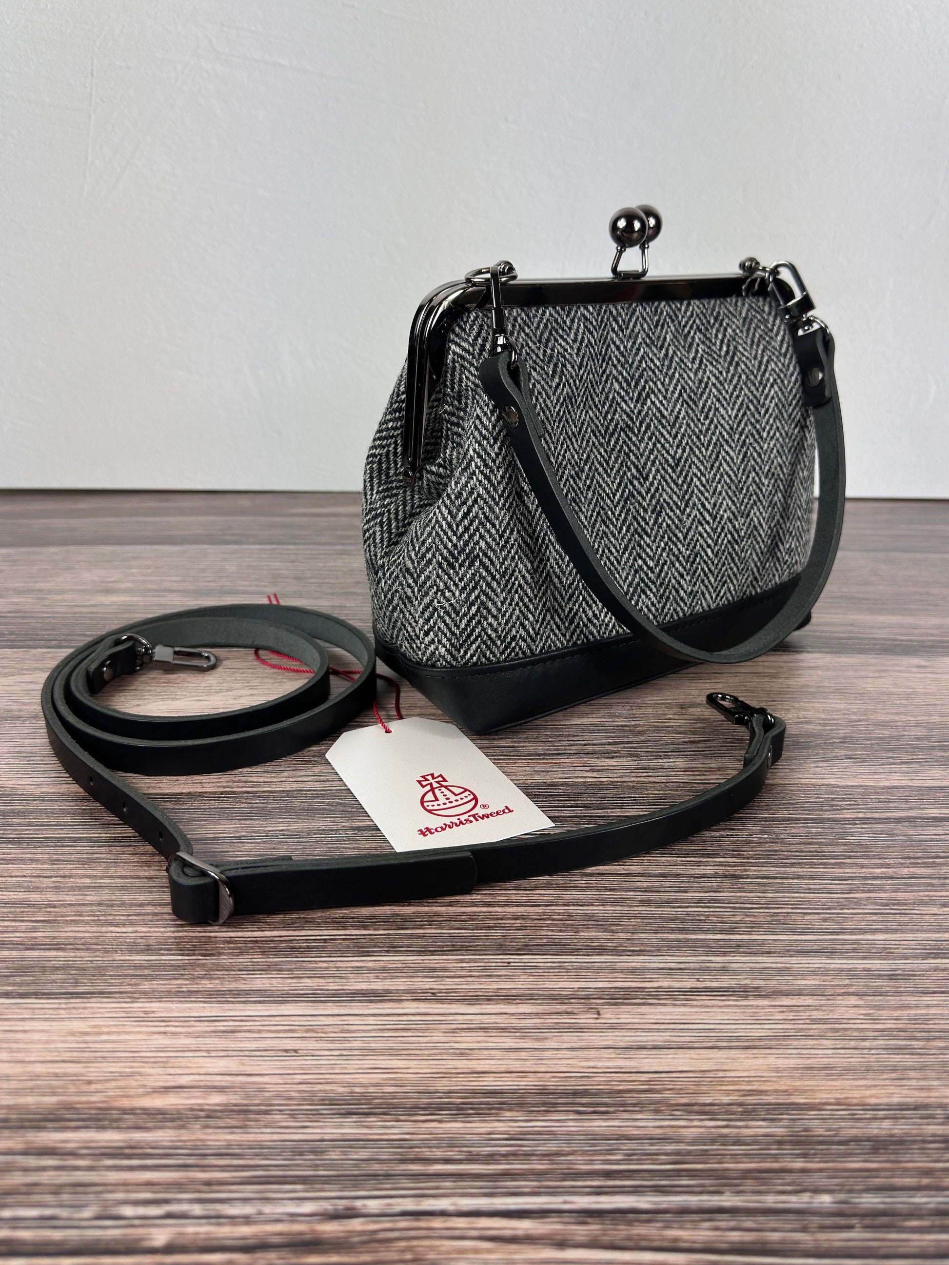 Harris Tweed® Princess Anne Kiss Lock Purse in Black and White Herringbone with leather base, handbag strap, and crossbody strap — handcrafted in Maryland.