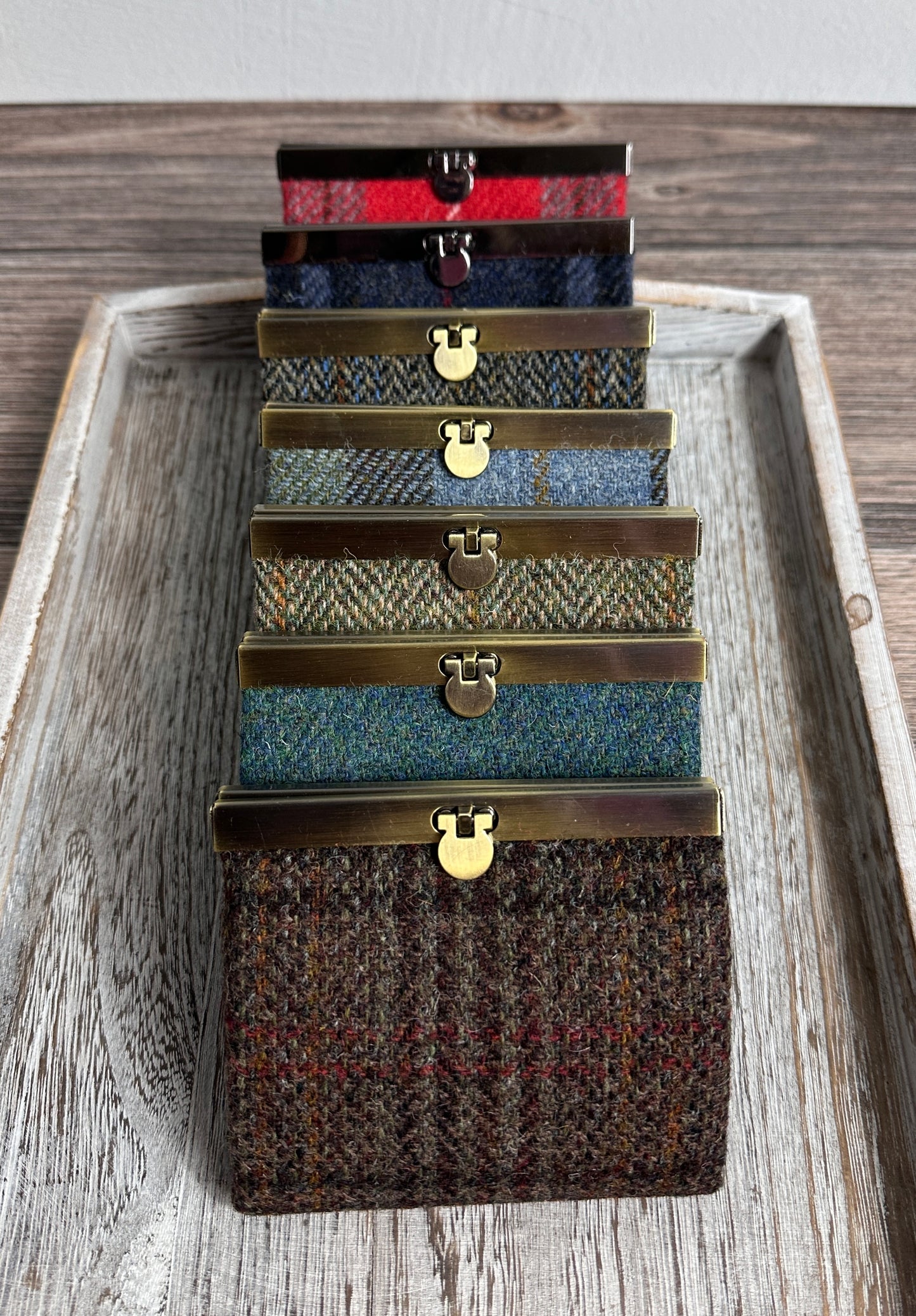 Collection of structured Mini Harris Tweed® Rock Hall Wallets, all featuring the slim accordion design and sleek metal flip-lock hardware.