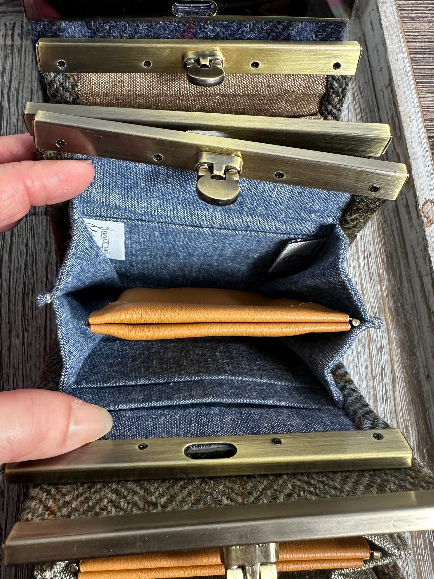 Open Mini Harris Tweed® Rock Hall Wallet showing the linen interior, two card slots, and the removable coin pocket in a slim accordion-style design.