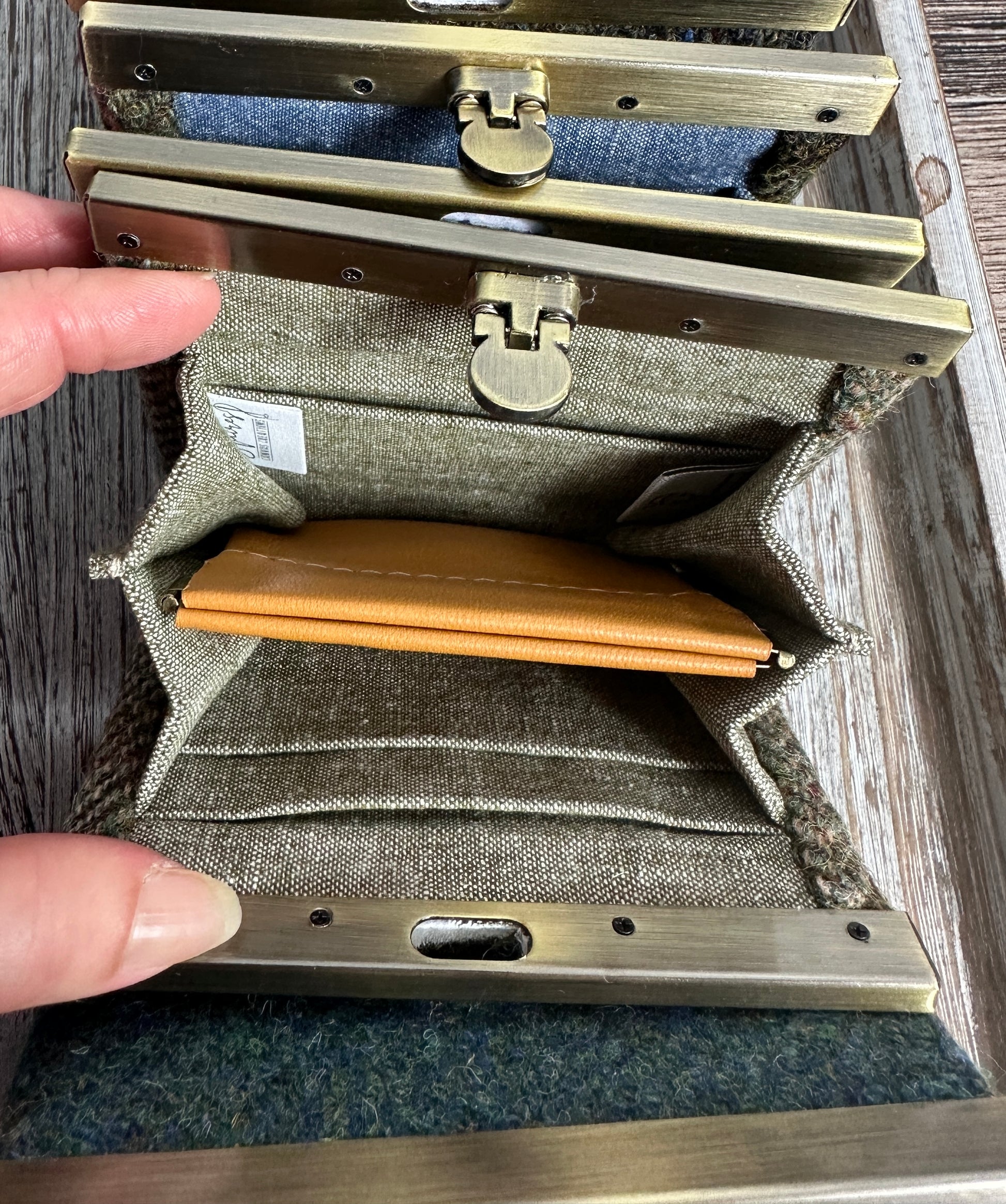 Open Mini Harris Tweed® Rock Hall Wallet showing the linen interior, two card slots, and the removable coin pocket in a slim accordion-style design.