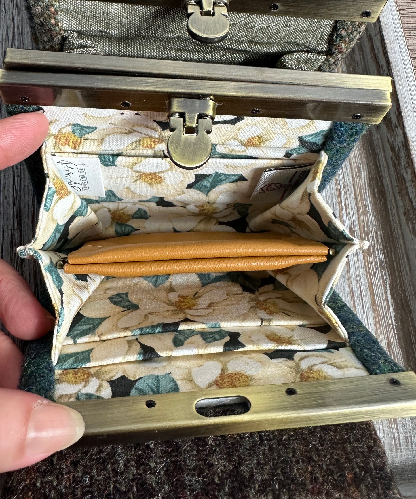 Open Mini Harris Tweed® Rock Hall Wallet showing the linen interior, two card slots, and the removable coin pocket in a slim accordion-style design.