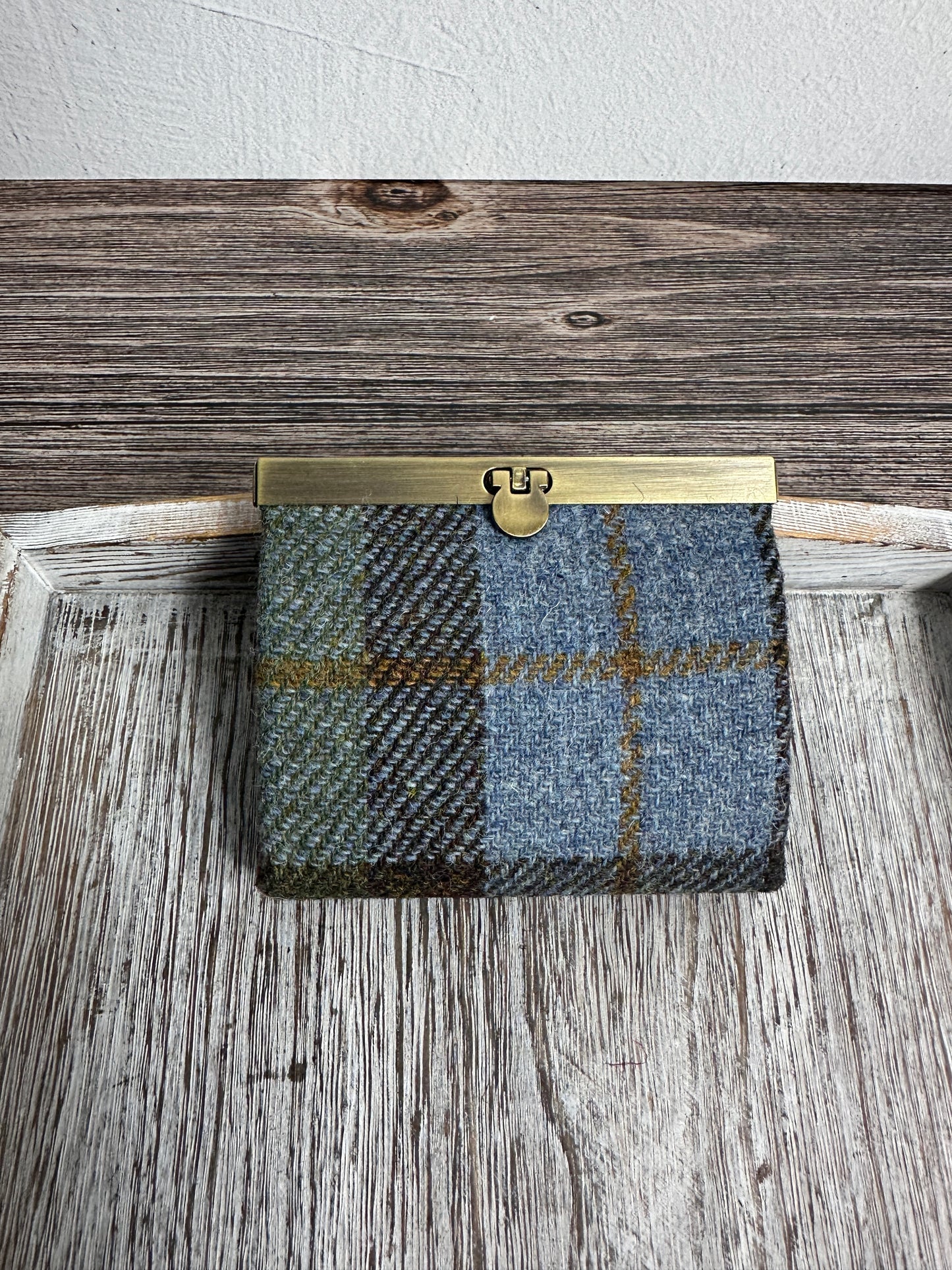 Closed Mini Harris Tweed® Rock Hall Wallet in Macleod pattern, featuring Antique Brass flip-lock closure.