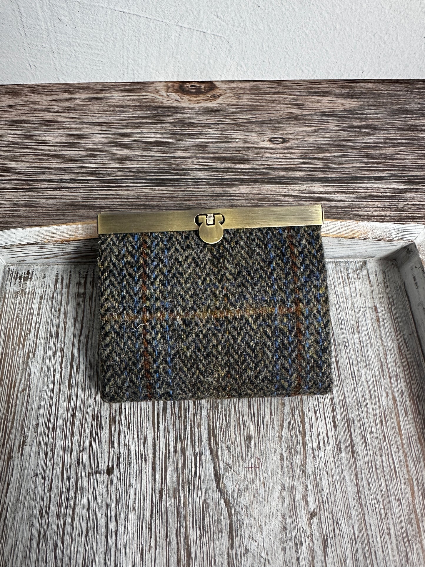 Closed Mini Harris Tweed® Rock Hall Wallet in Green Blue Herringbone, featuring Antique Brass flip-lock closure.