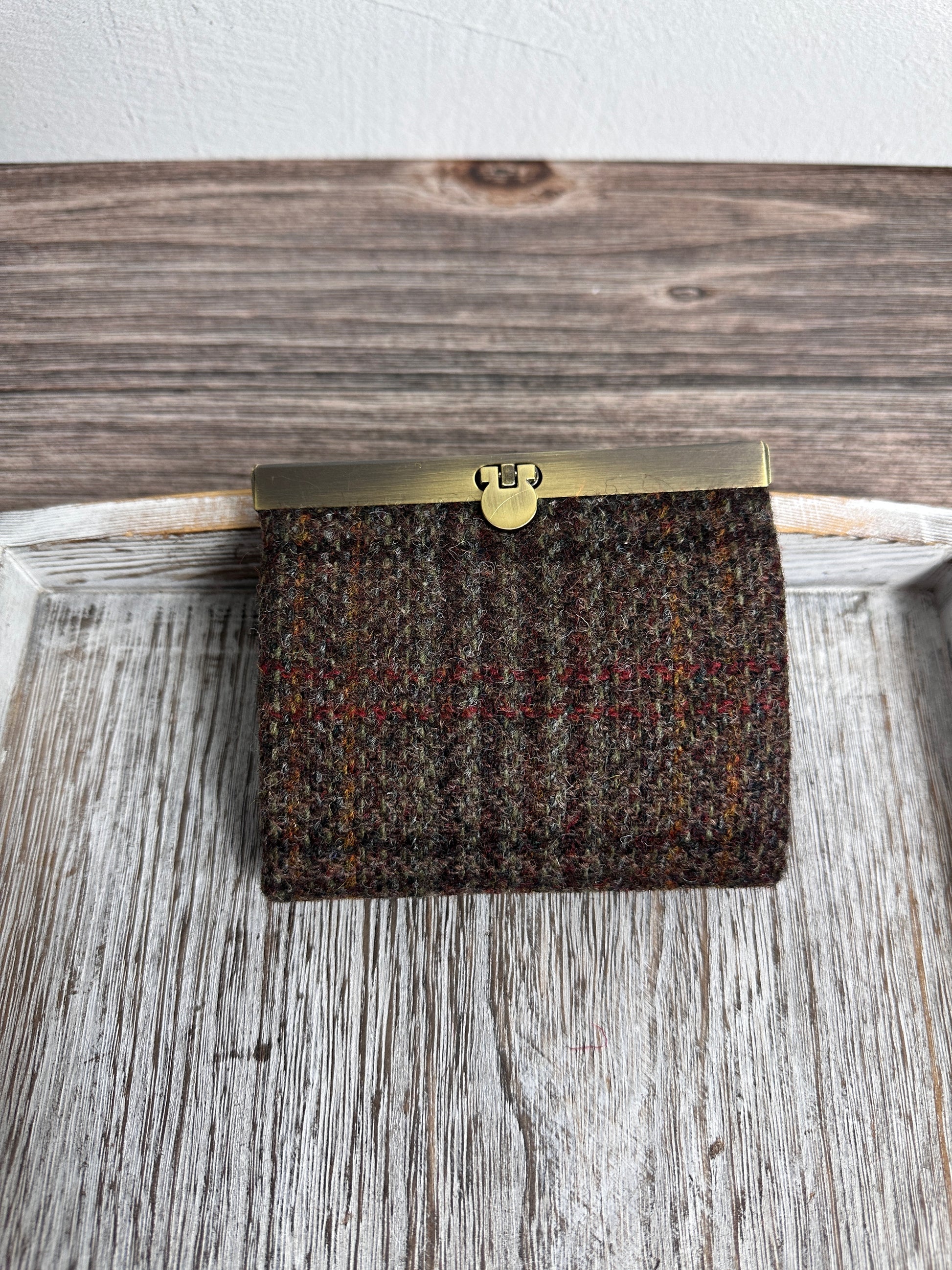 Closed Mini Harris Tweed® Rock Hall Wallet in Dark Brown Plaid, featuring Antique Brass flip-lock closure.
