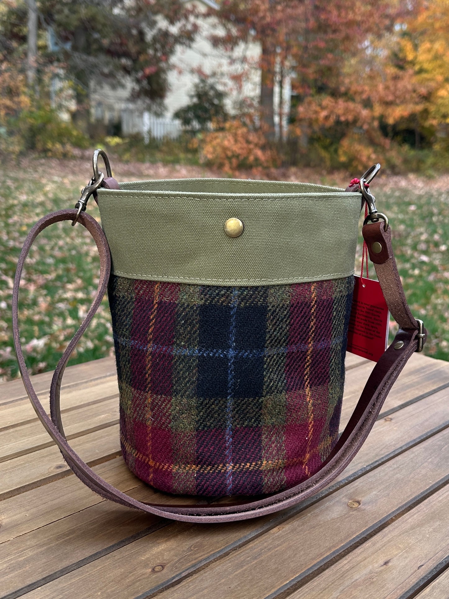 Green Red and Black Harris Tweed® Lighthouse Crossbody round bag with flat bottom and Hybrid Waxed Canvas Accents