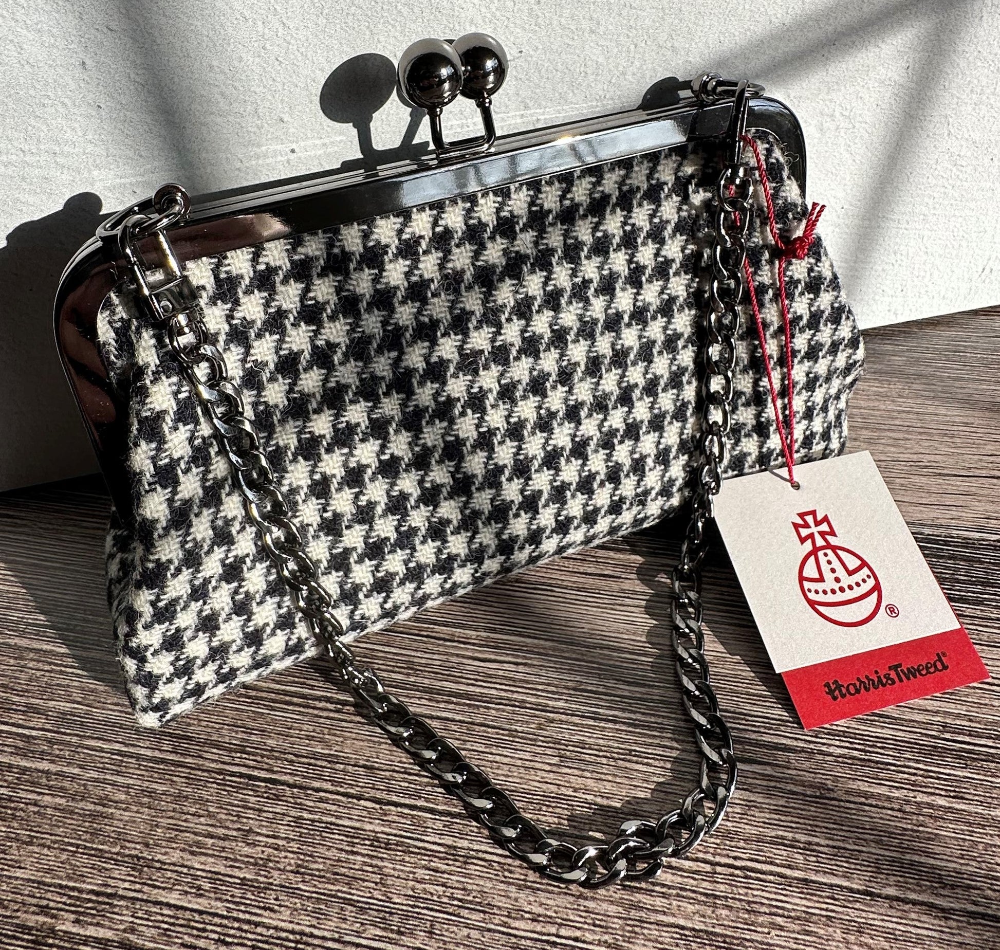 Handcrafted Harris Tweed® kiss lock purse in Black and White Houndstooth with gunmetal hardware. Classic and elegant, made in Maryland.