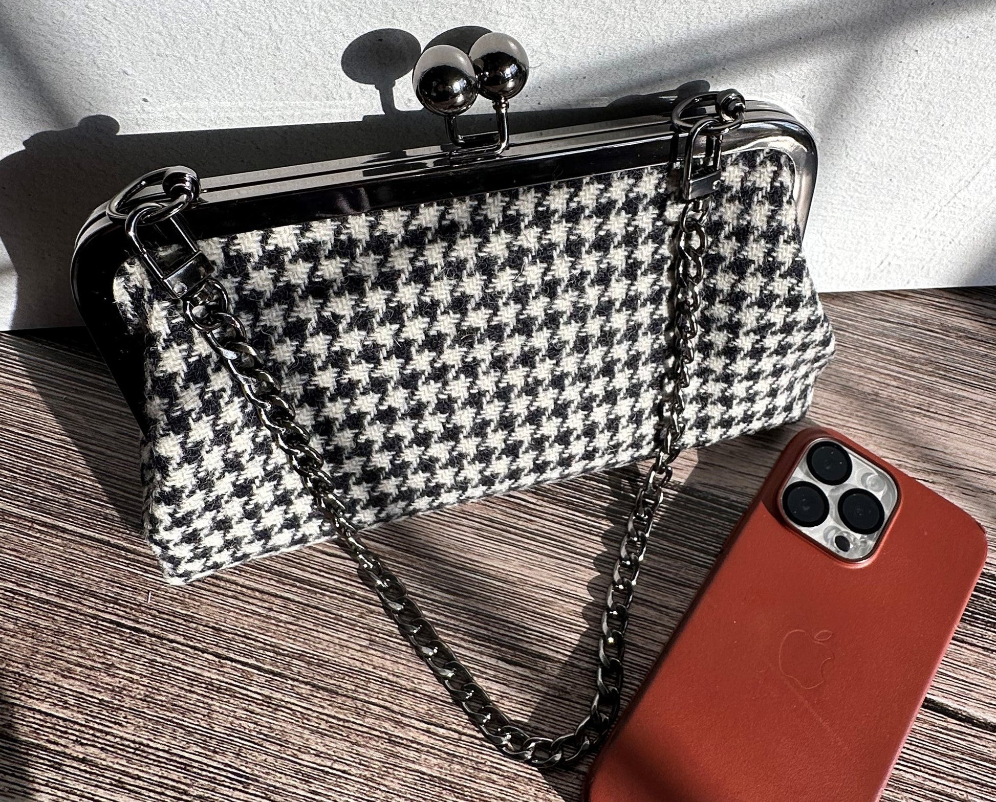 Handcrafted Harris Tweed® kiss lock purse in Black and White Houndstooth with gunmetal hardware. Classic and elegant, made in Maryland.