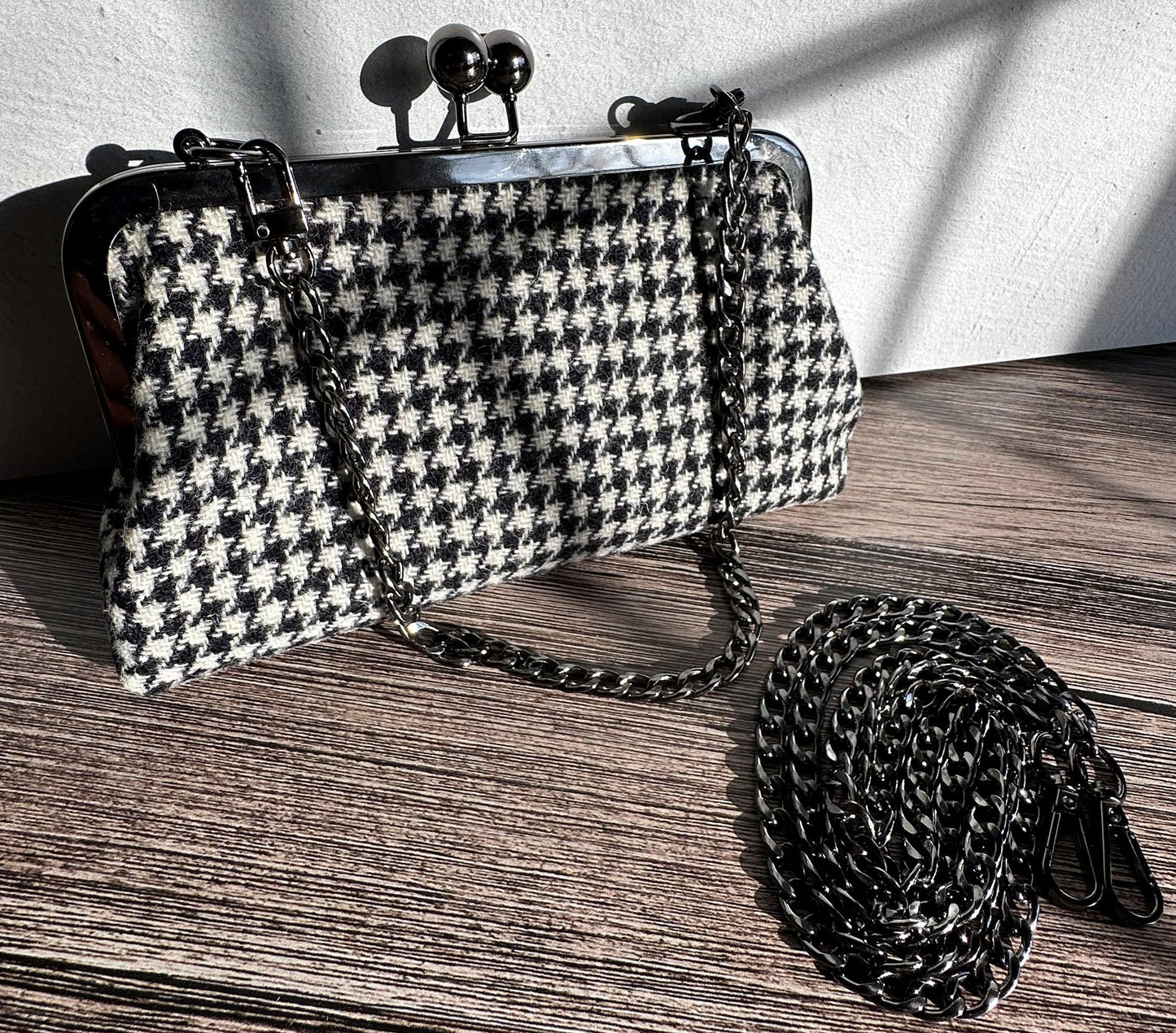 Handcrafted Harris Tweed® kiss lock purse in Black and White Houndstooth with gunmetal hardware. Classic and elegant, made in Maryland.