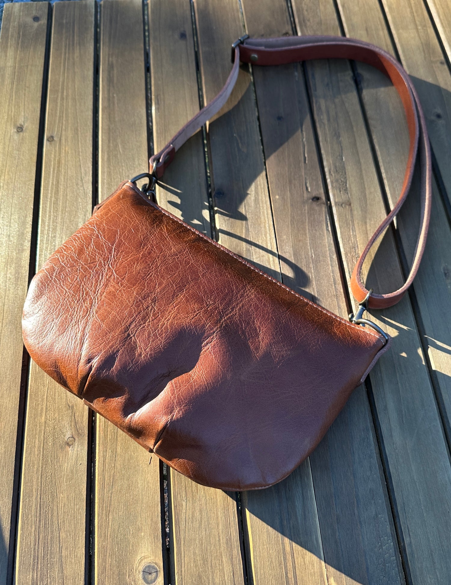 Sienna Leather Holland Island Crossbody bag with antique brass hardware and adjustable strap.