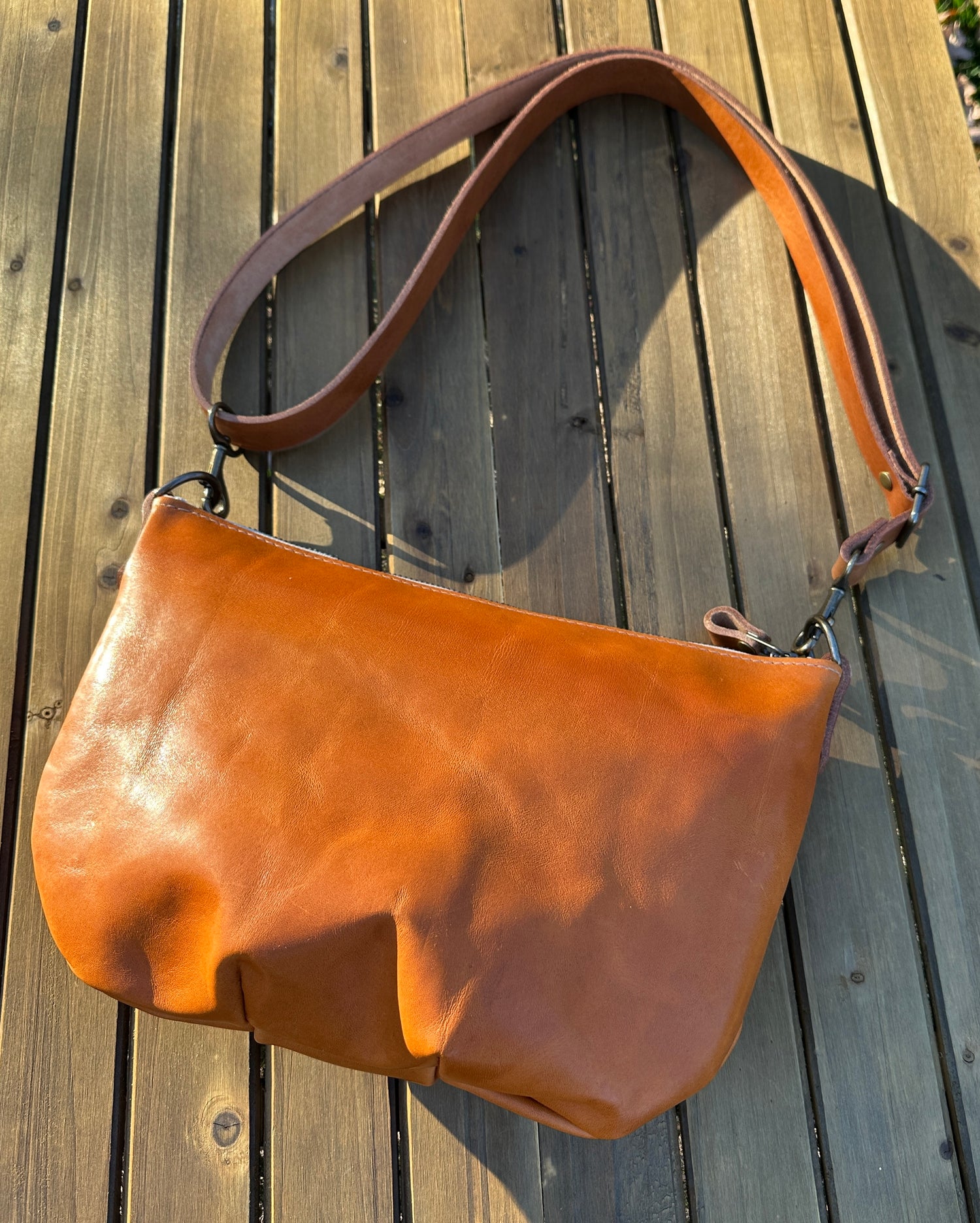 Acorn Leather Holland Island Crossbody bag with antique brass hardware and adjustable strap.