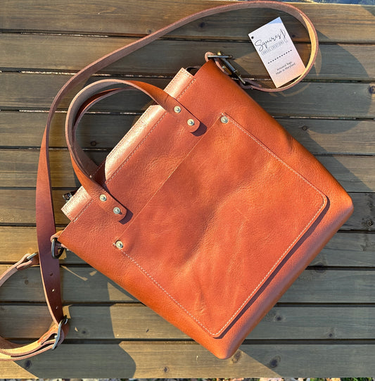 Flat view of the Cherry West Street Crossbody bag made with vegetable-tanned leather.