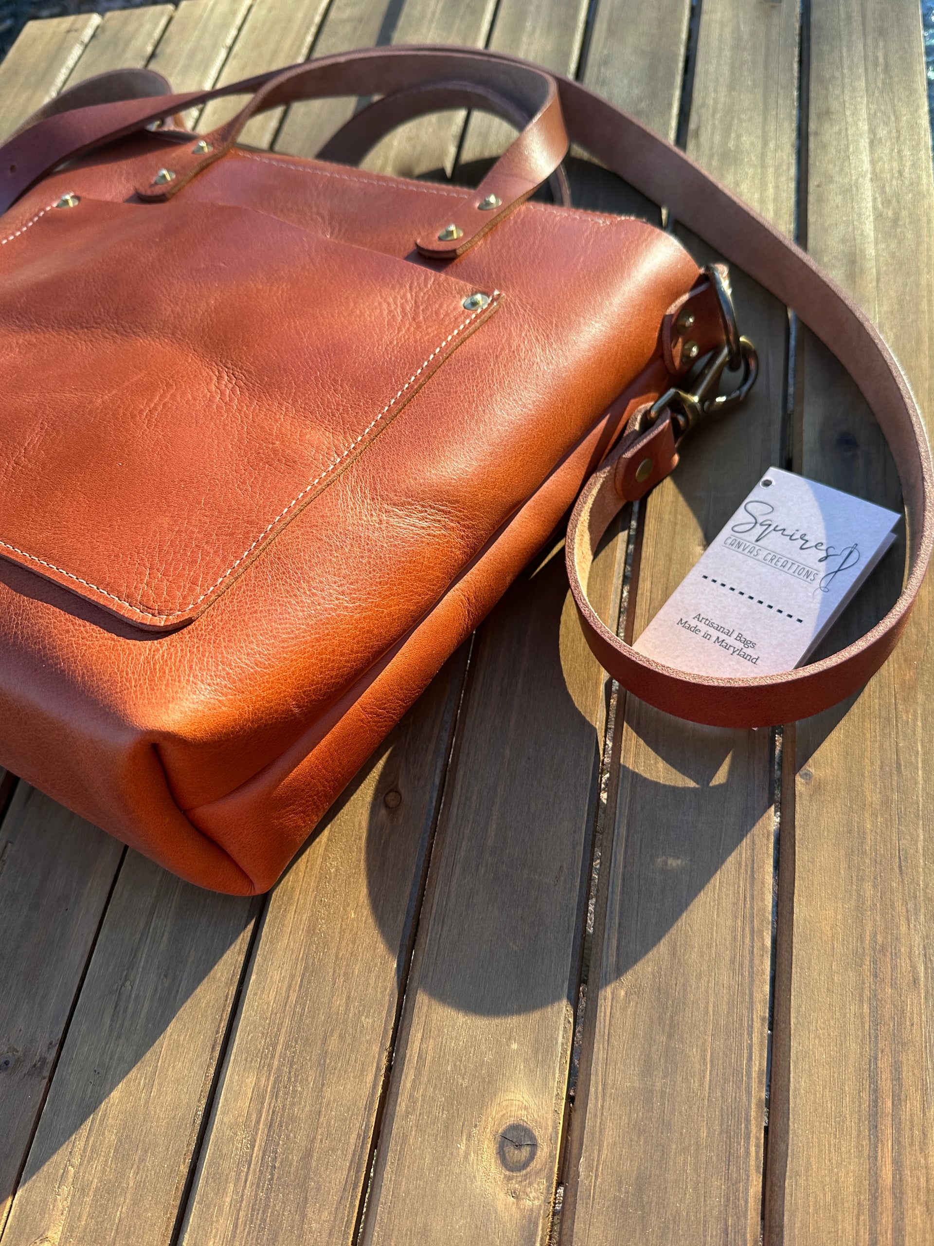 Flat side view of the Cherry West Street Crossbody bag made with vegetable-tanned leather.