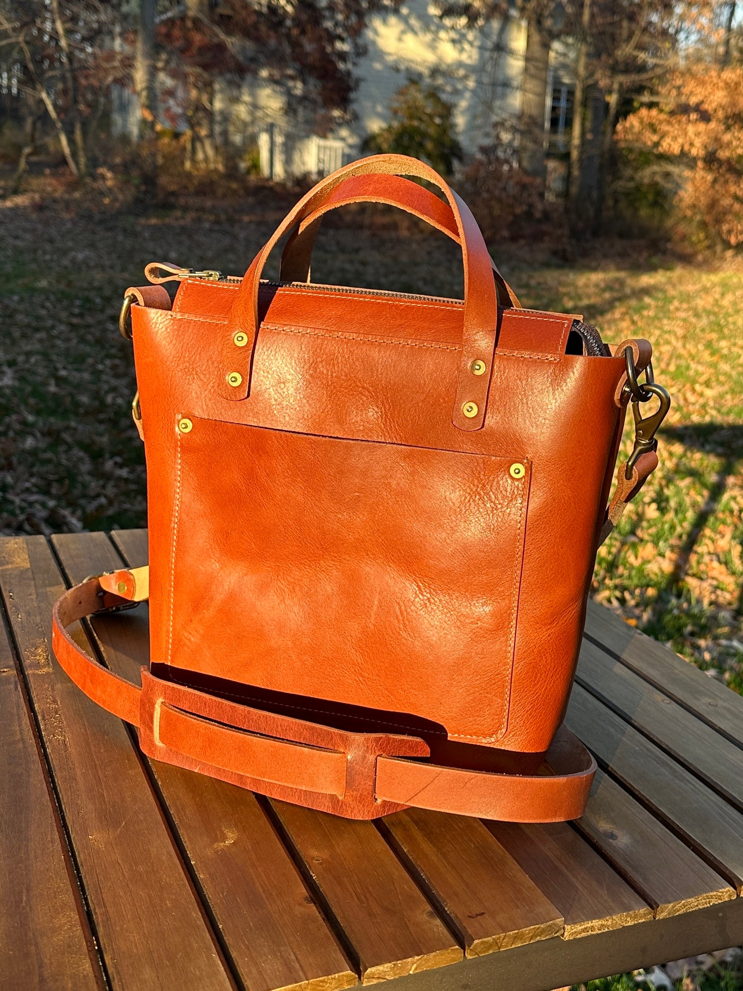 Cherry leather West Street Crossbody tote with clean minimalist front design.