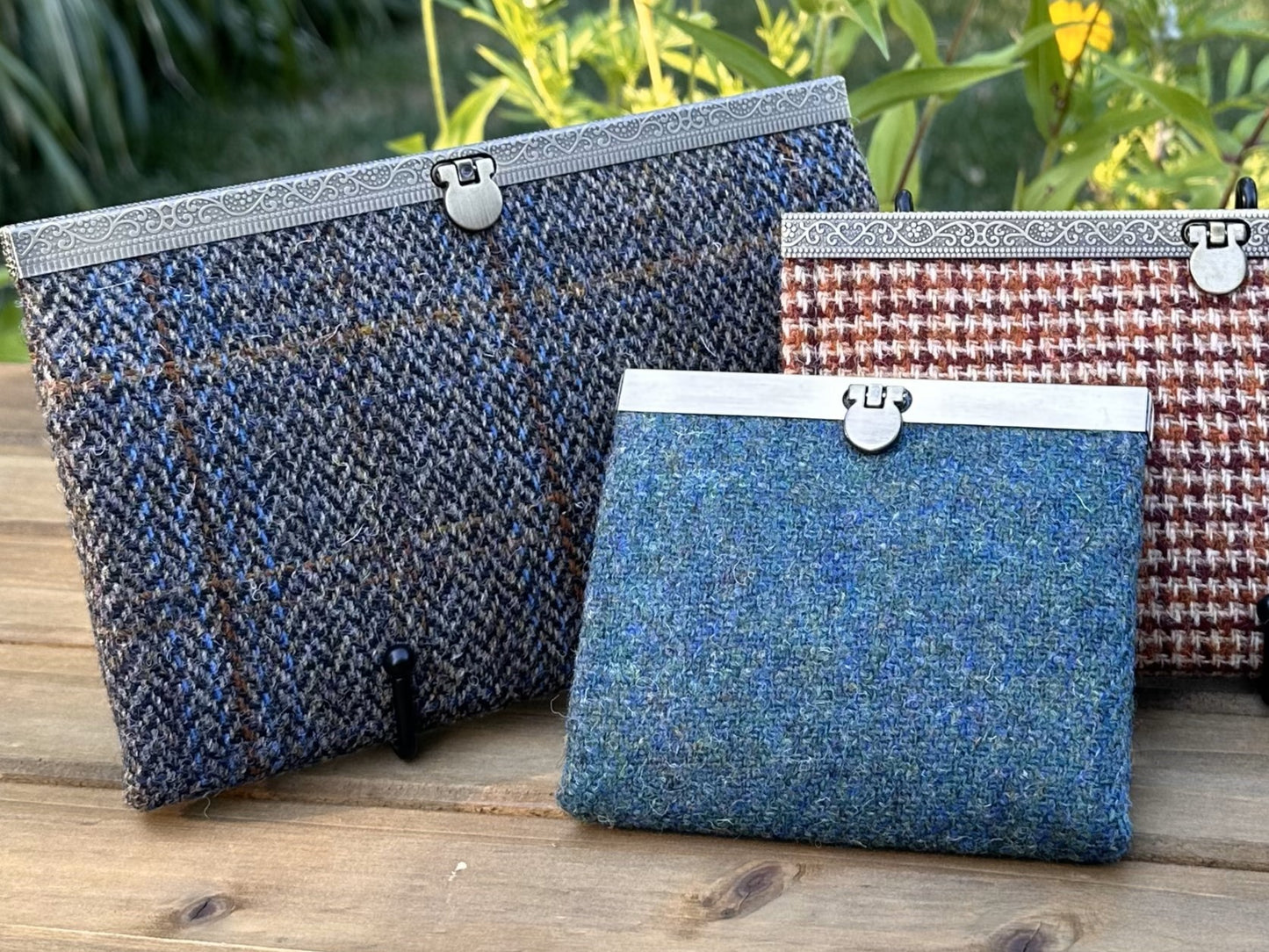 Collection of structured Large and one Mini Harris Tweed® Rock Hall Wallets, all featuring the slim accordion design and sleek metal flip-lock hardware.