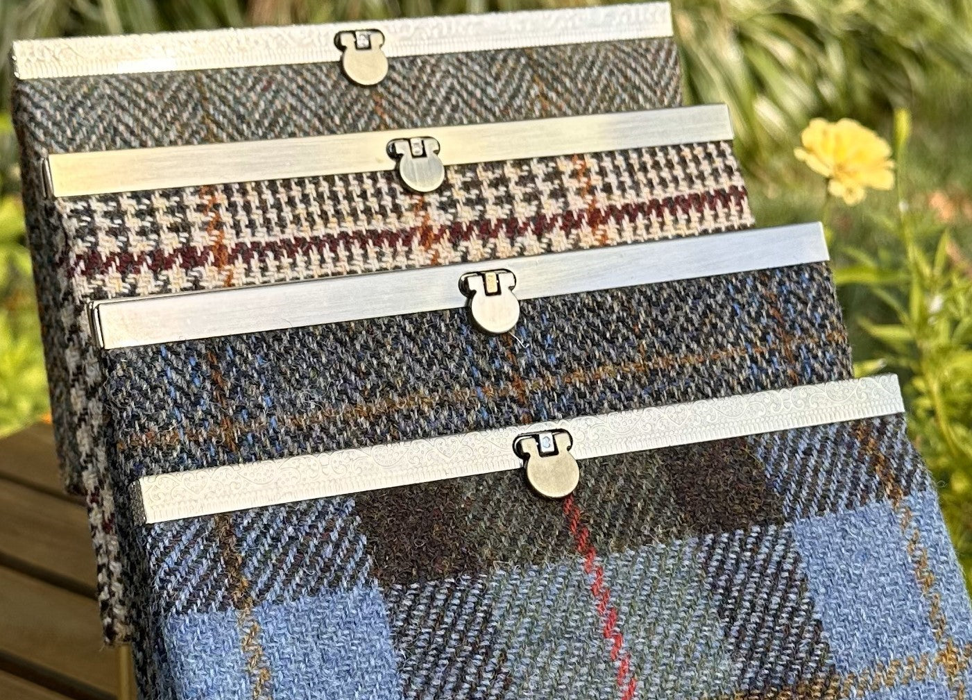 Collection of structured Large Harris Tweed® Rock Hall Wallets, all featuring the slim accordion design and sleek metal flip-lock hardware.