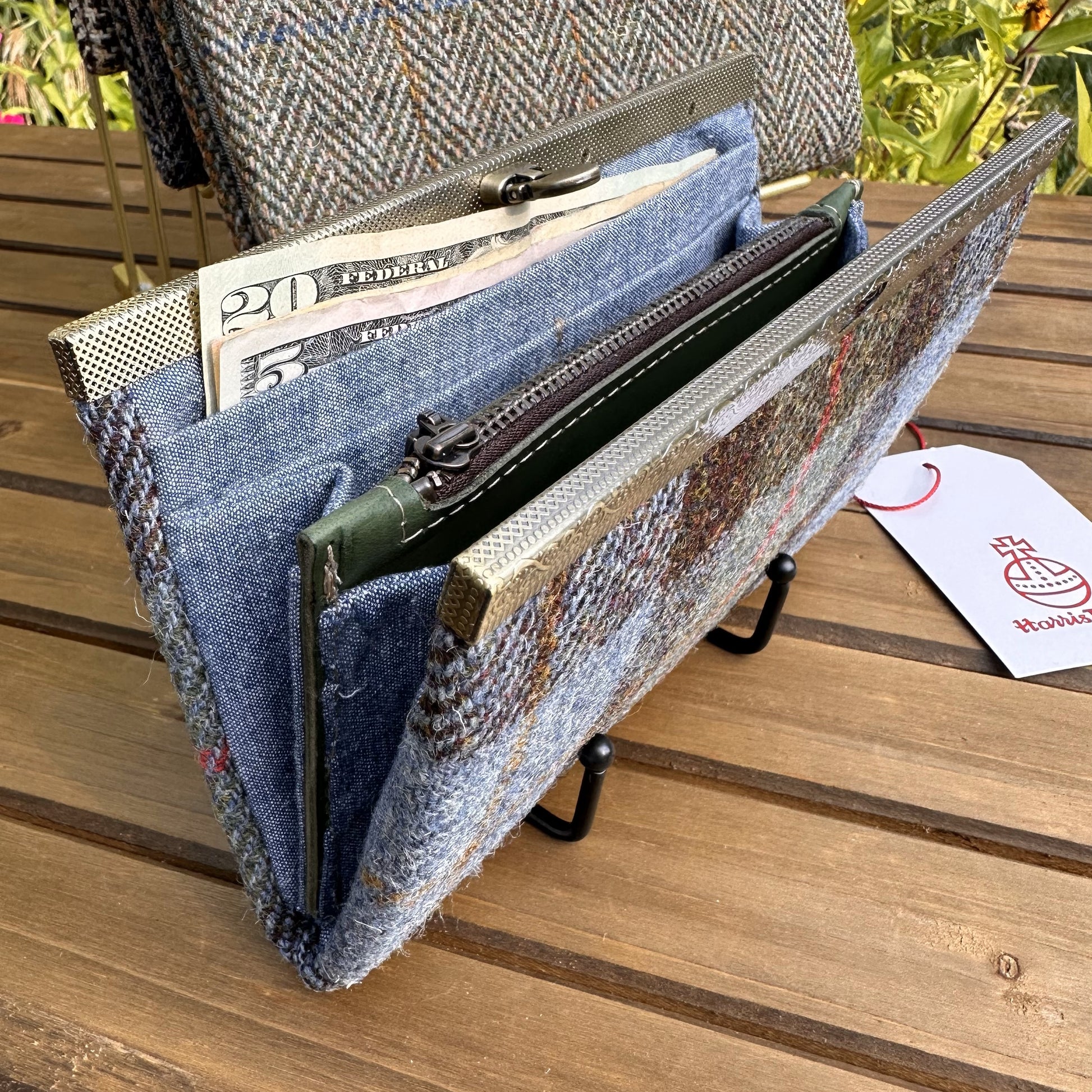 Interior view of the open Harris Tweed® Large Rock Hall Wallet, highlighting the organization features: card slots, cash slip pocket, and leather zipper coin pouch.