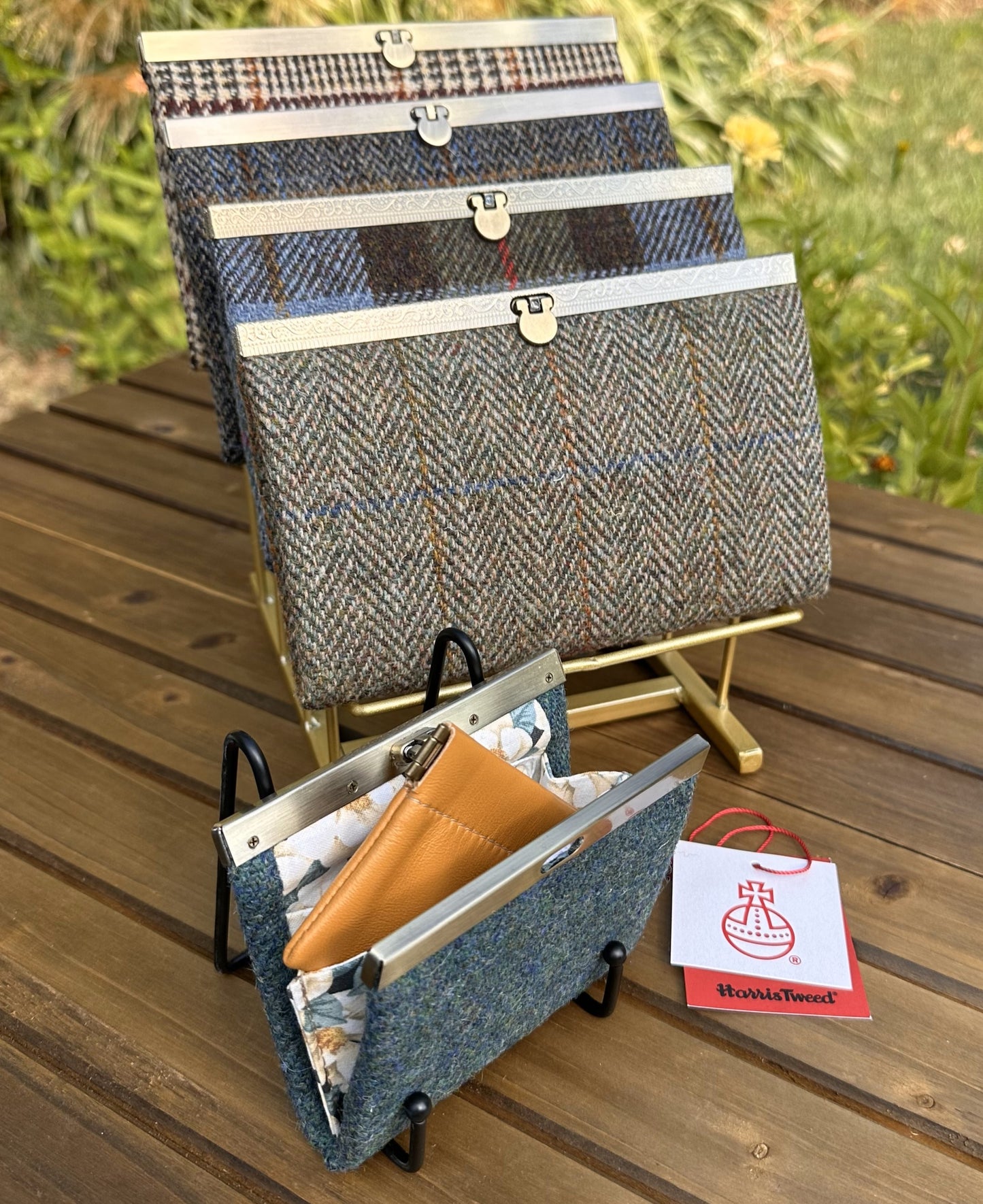 Collection of structured Large and one Mini Harris Tweed® Rock Hall Wallets, all featuring the slim accordion design and sleek metal flip-lock hardware.