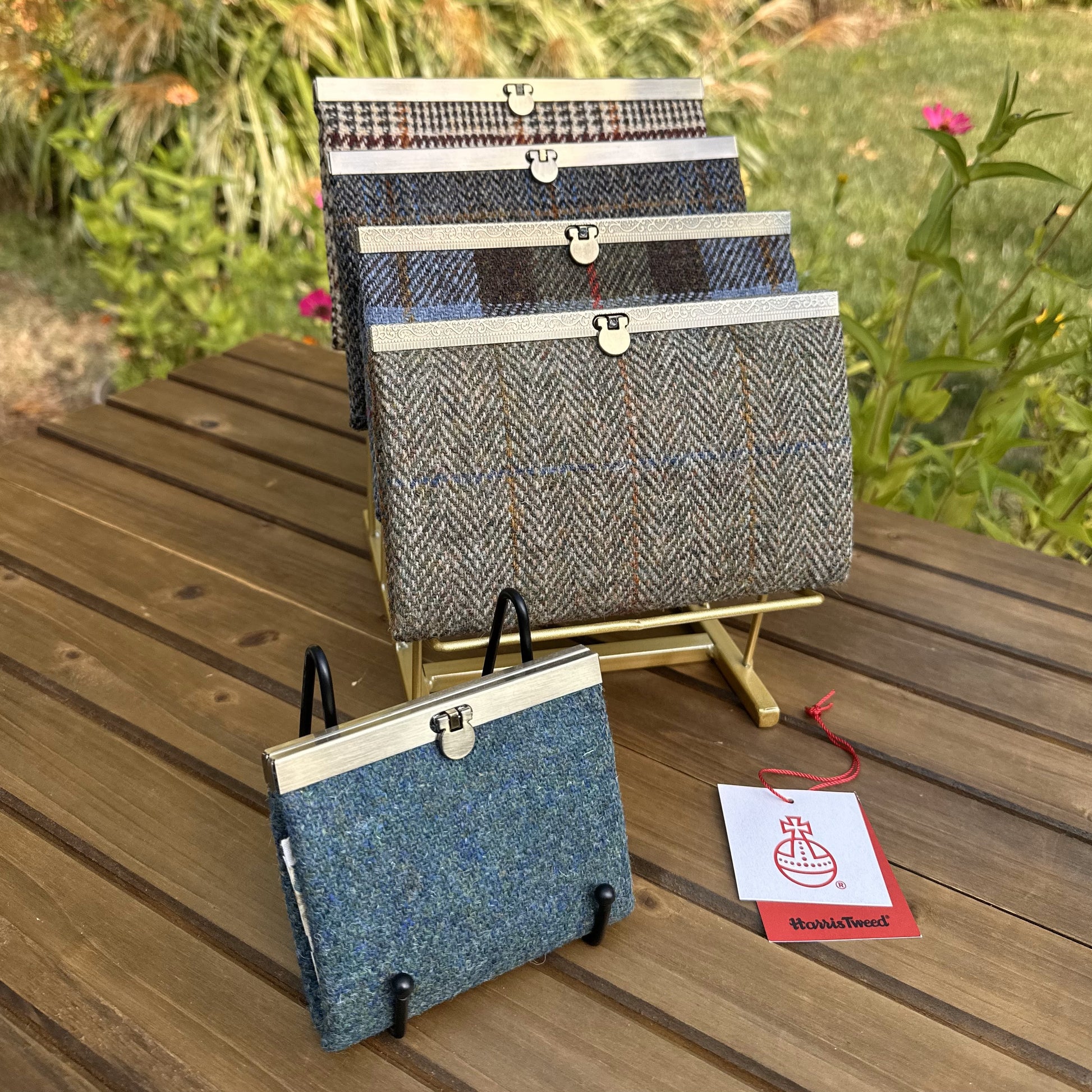 Collection of structured Large and one Mini Harris Tweed® Rock Hall Wallets, all featuring the slim accordion design and sleek metal flip-lock hardware.