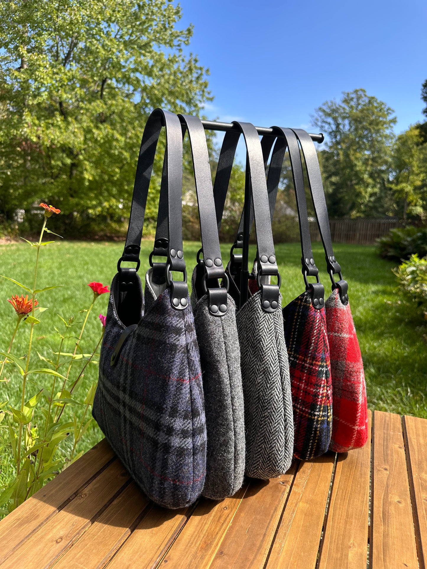 Harris Tweed® Rhode River Shoulder Bags five bags, with different prints and black leather combos paired with black matte Hardware. Handcrafted in Maryland