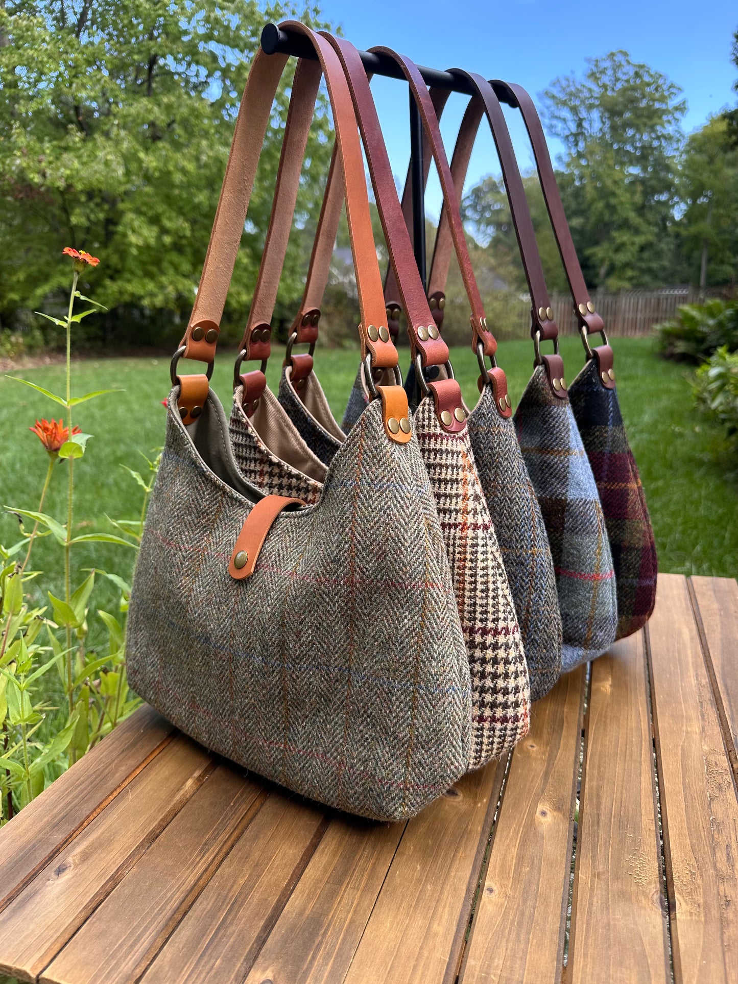 Harris Tweed® Rhode River Shoulder Bags five bags, with different prints and leather combos paired with Antique Brass Hardware. Handcrafted in Maryland