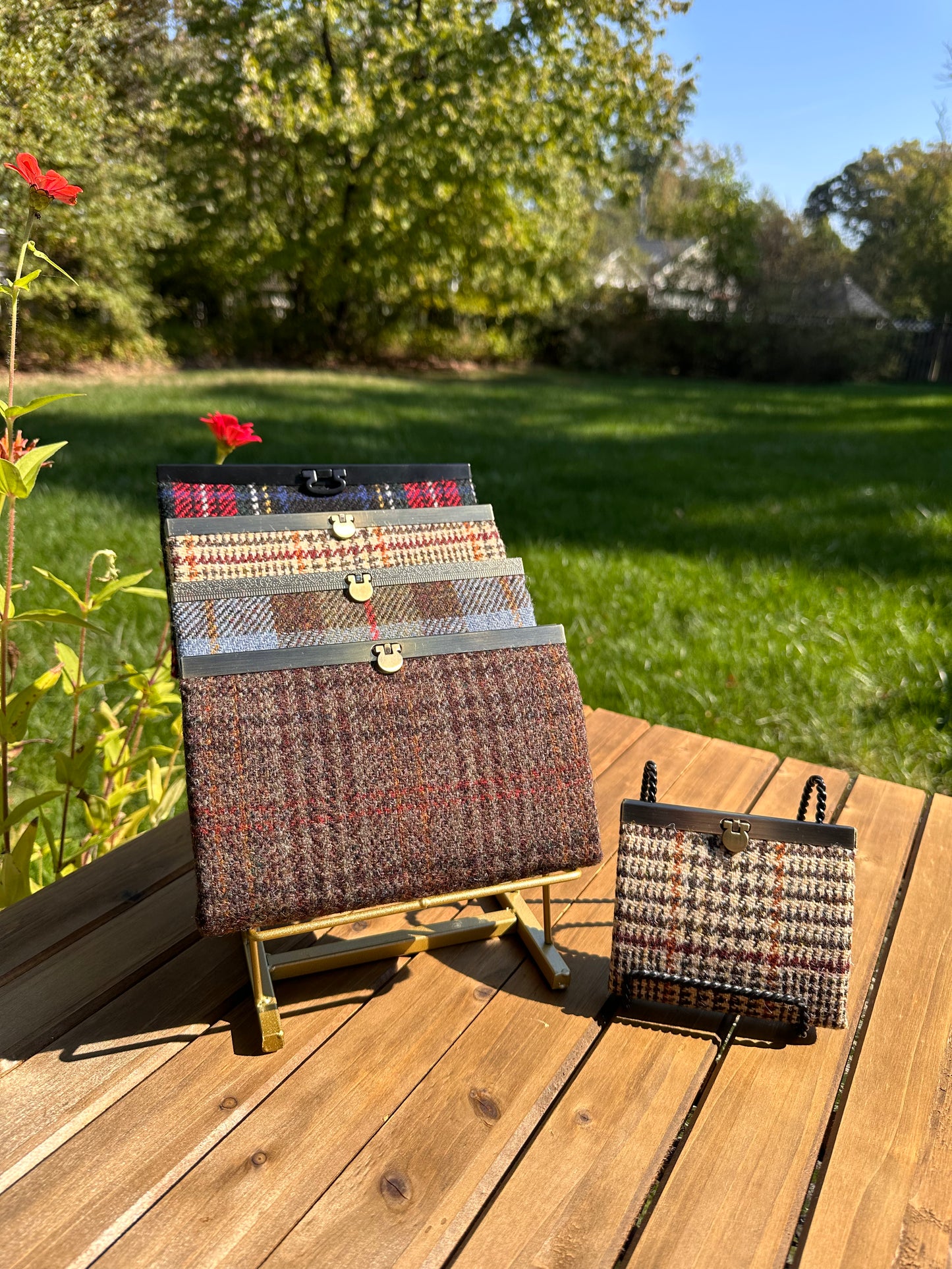 Collection of structured Large and one Mini Harris Tweed® Rock Hall Wallets, all featuring the slim accordion design and sleek metal flip-lock hardware.