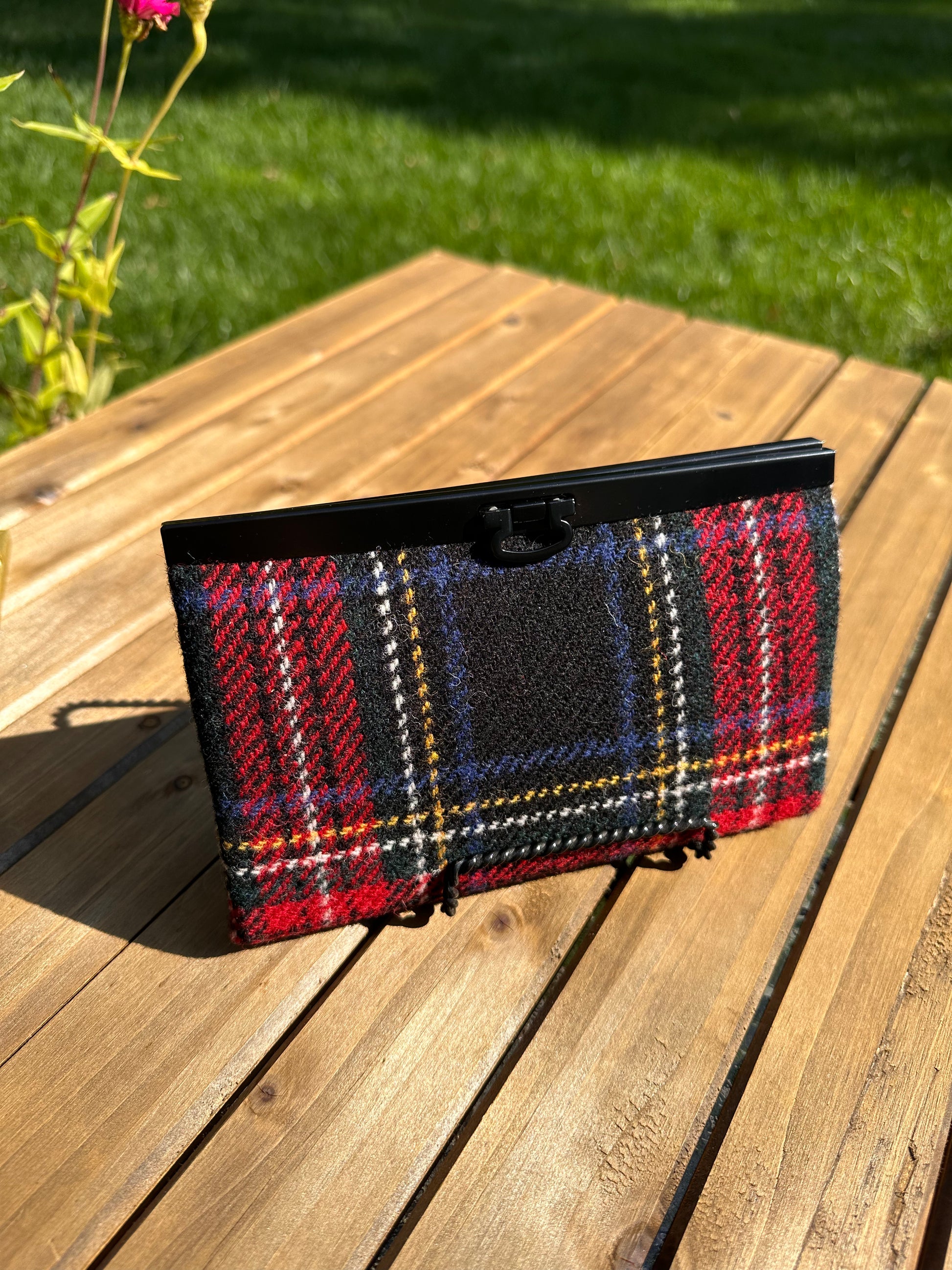 Closed Large Harris Tweed® Stewart Plaid Rock Hall Wallet features Black Matte Hardware flip-lock closure.