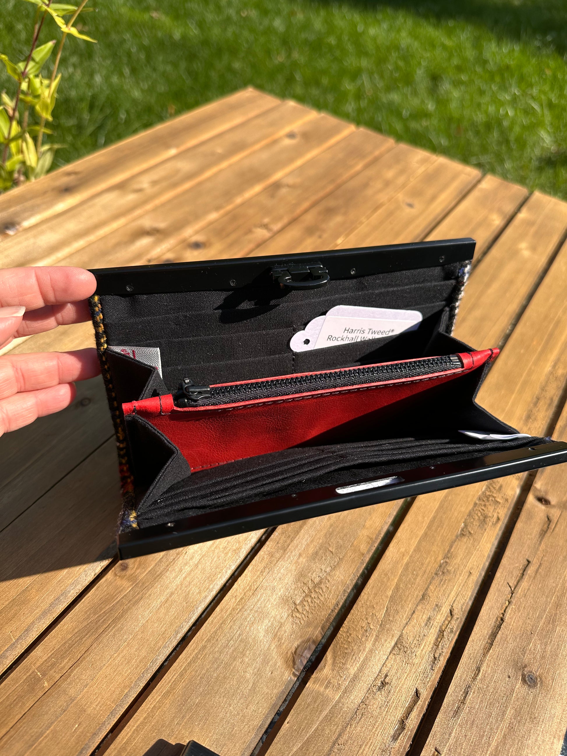 Interior view of the open Harris Tweed® Large Rock Hall Wallet, highlighting the organization features: card slots, cash slip pocket, and leather zipper coin pouch.
