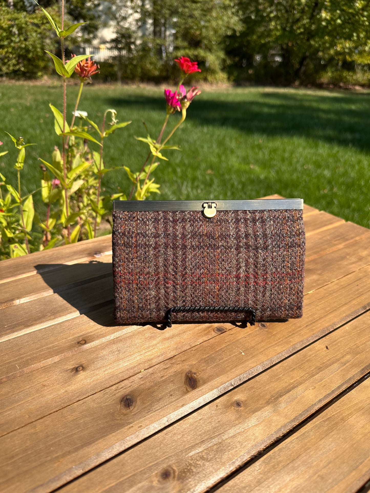 Closed Large Harris Tweed® Dark Brown Plaid Rock Hall Wallet features Antique Brass Hardware flip-lock closure.