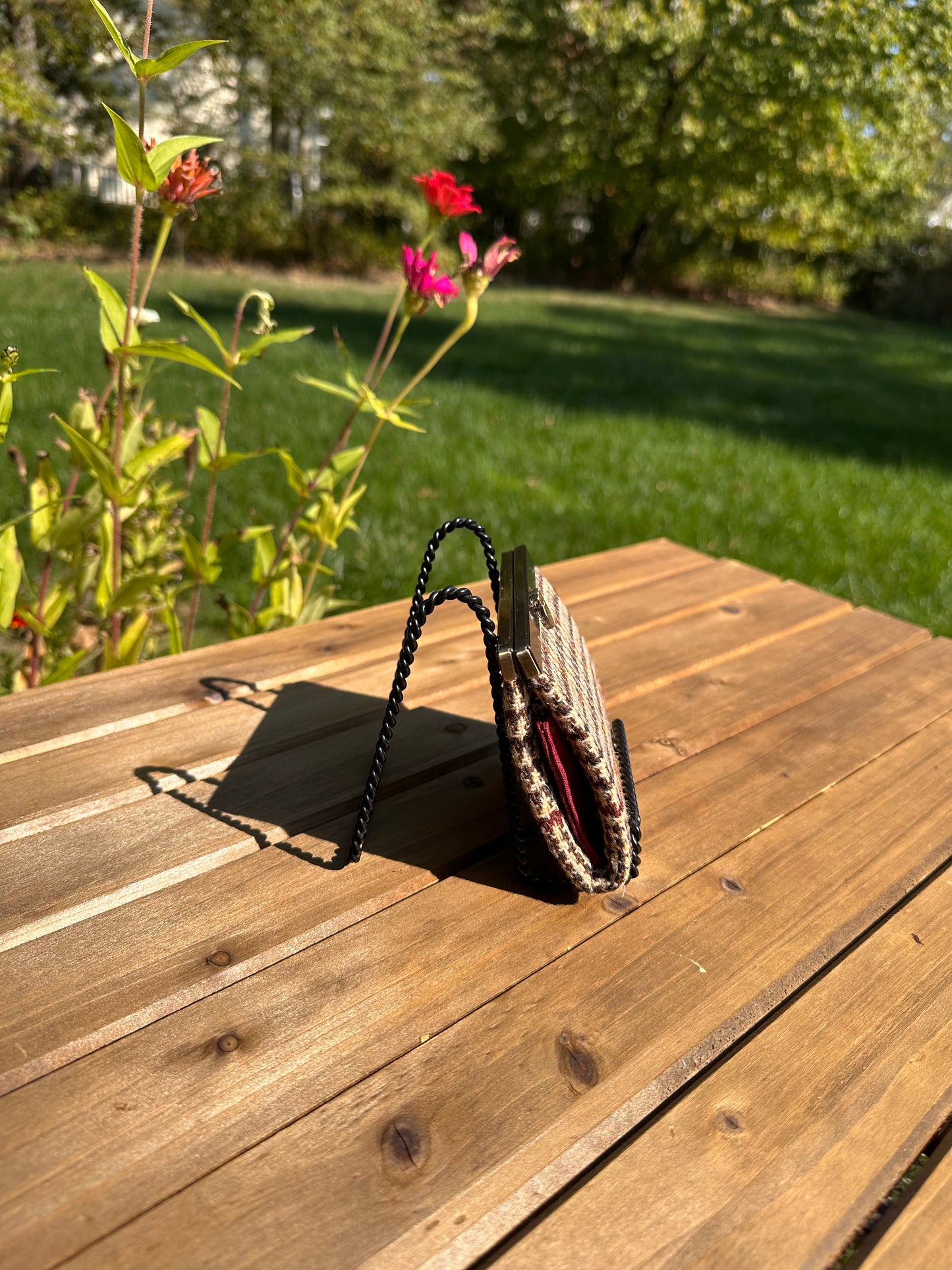 Close-up of the wallet's structured side profile, emphasizing the flexible accordion design which allows the compact Mini Rock Hall Wallet to expand slightly when full.