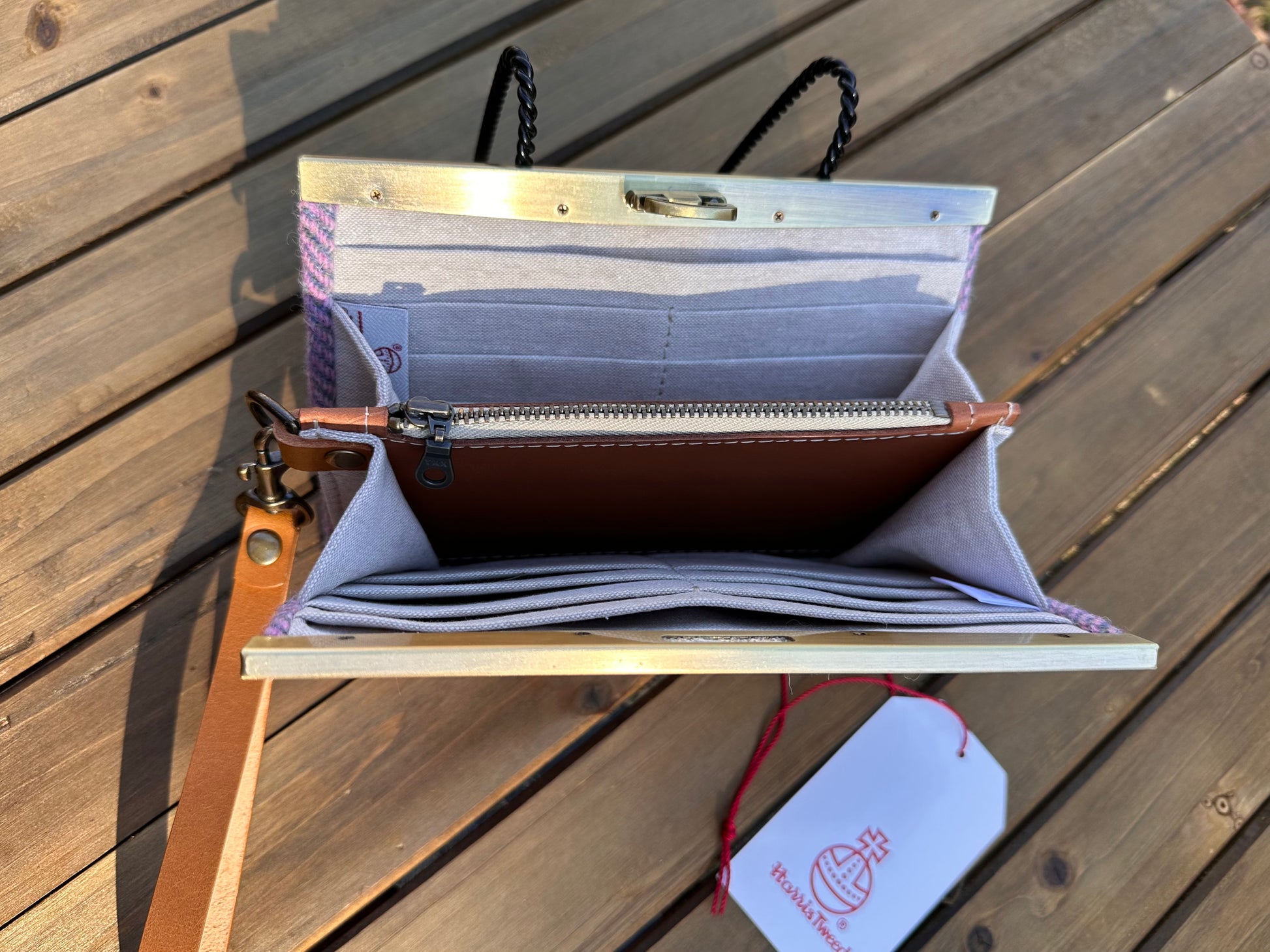 Interior view of the open Harris Tweed® Large Rock Hall Wallet, highlighting the organization features: card slots, cash slip pocket, and leather zipper coin pouch.