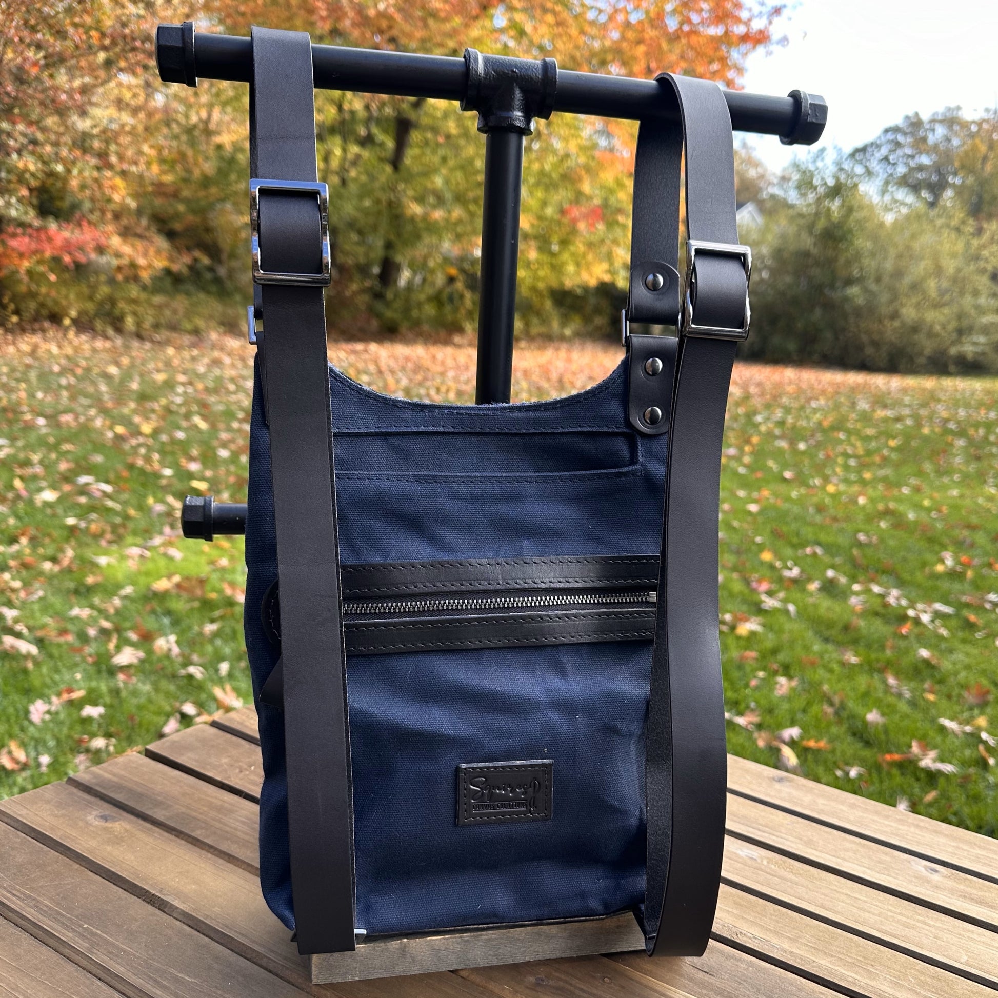 Blue Black and Grey Tartan with Red Overcheck Harris Tweed® and Dark Navy Waxed Canvas back with Solid Brass Hardware Harris Tweed® Eastport Backpack squirescanvascreations.com